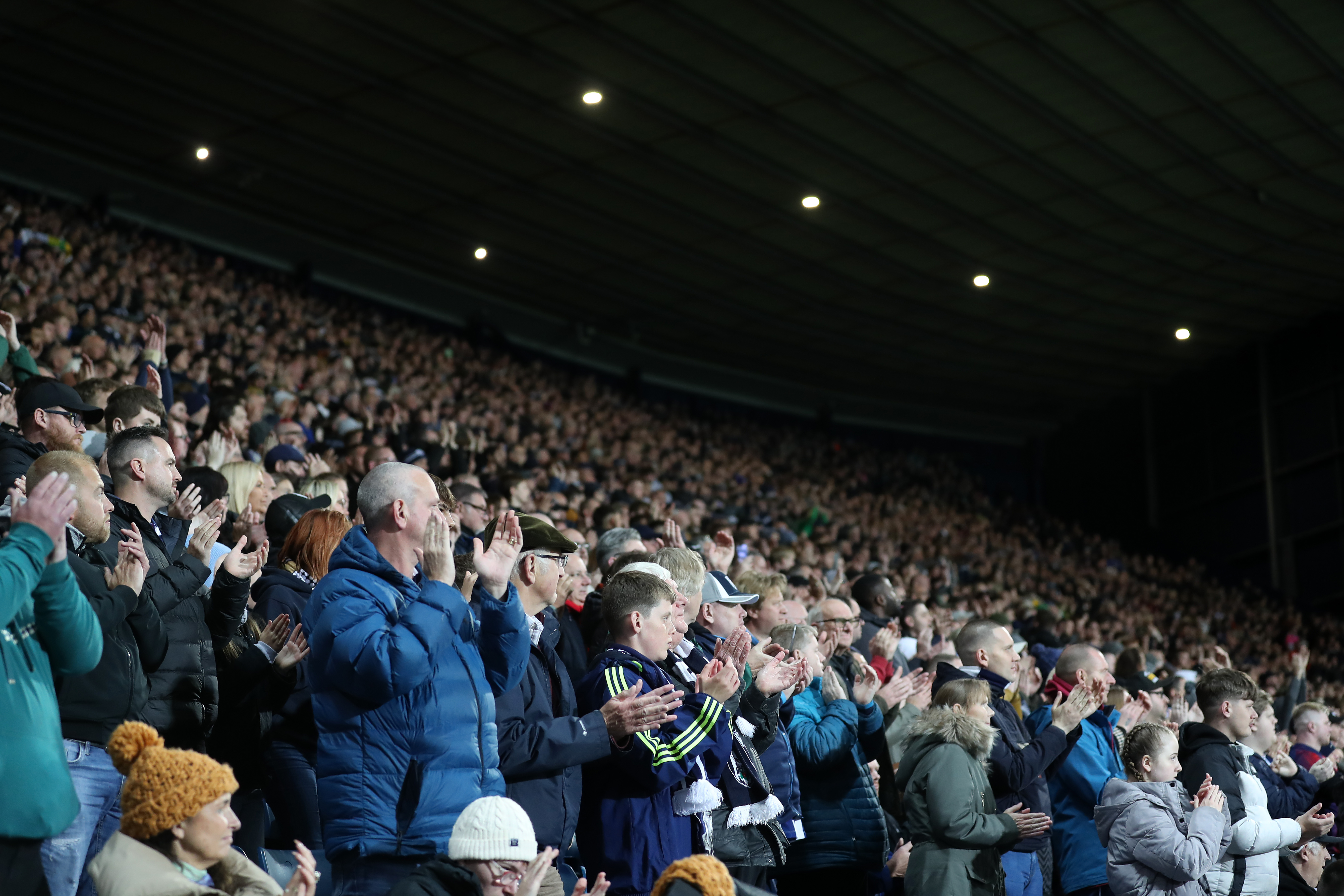 A general few of thousands of Albion fans applauding in the Brummie Road End 