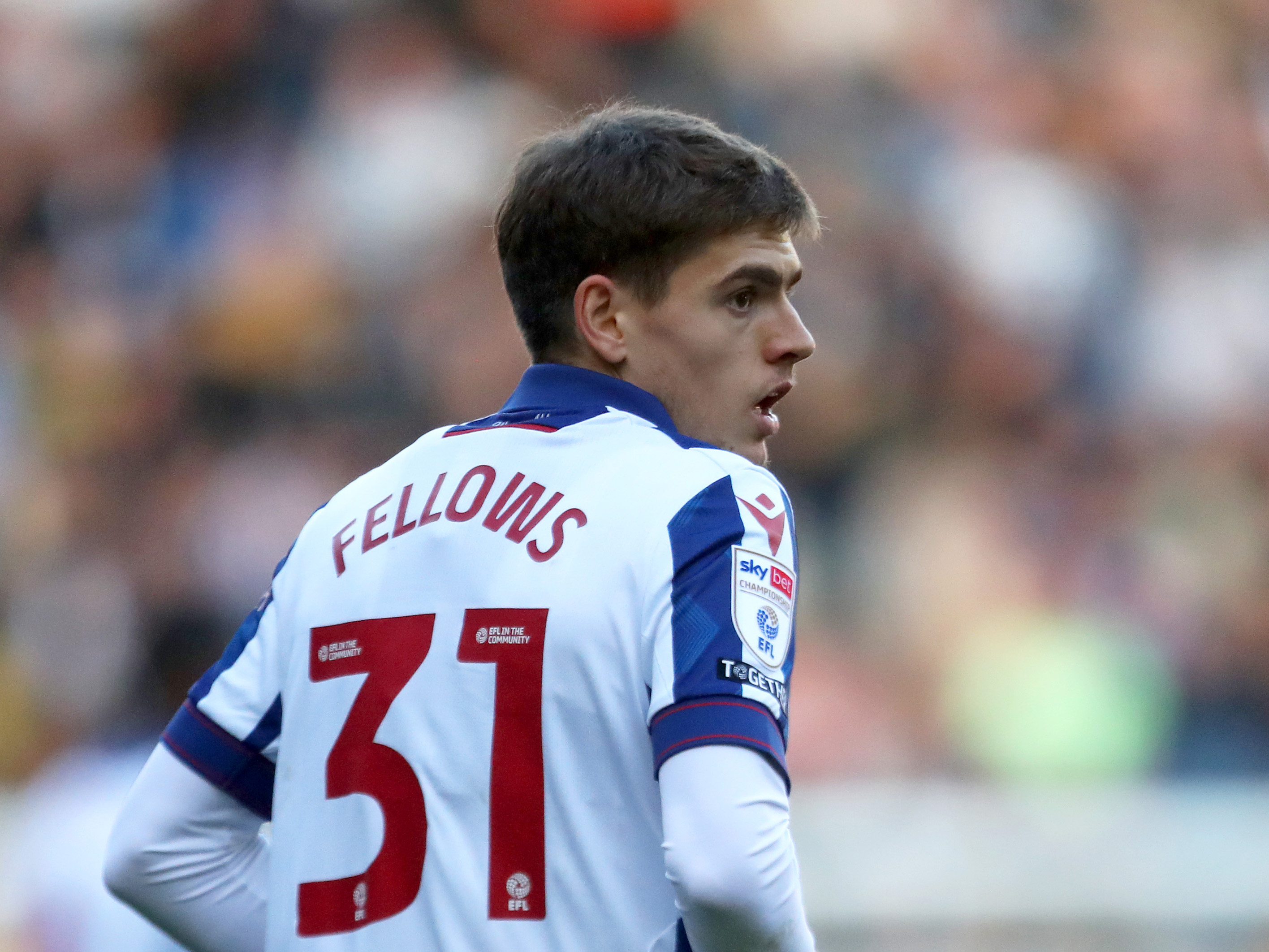 Tom Fellows looking over his shoulder with his name and No.31 on display on the home shirt 