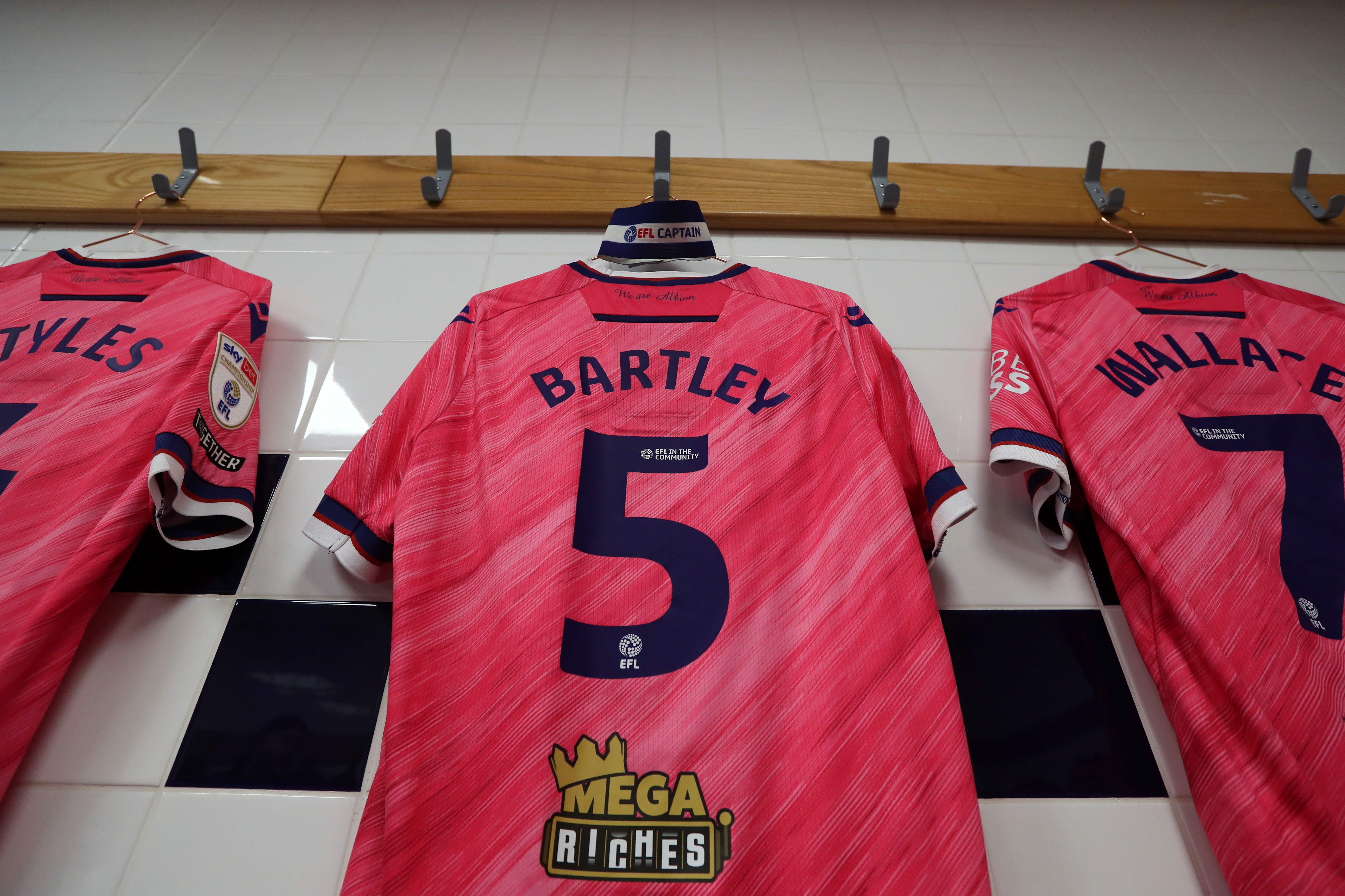 Kyle Bartley's pink away shirt hanging up in a dressing room 