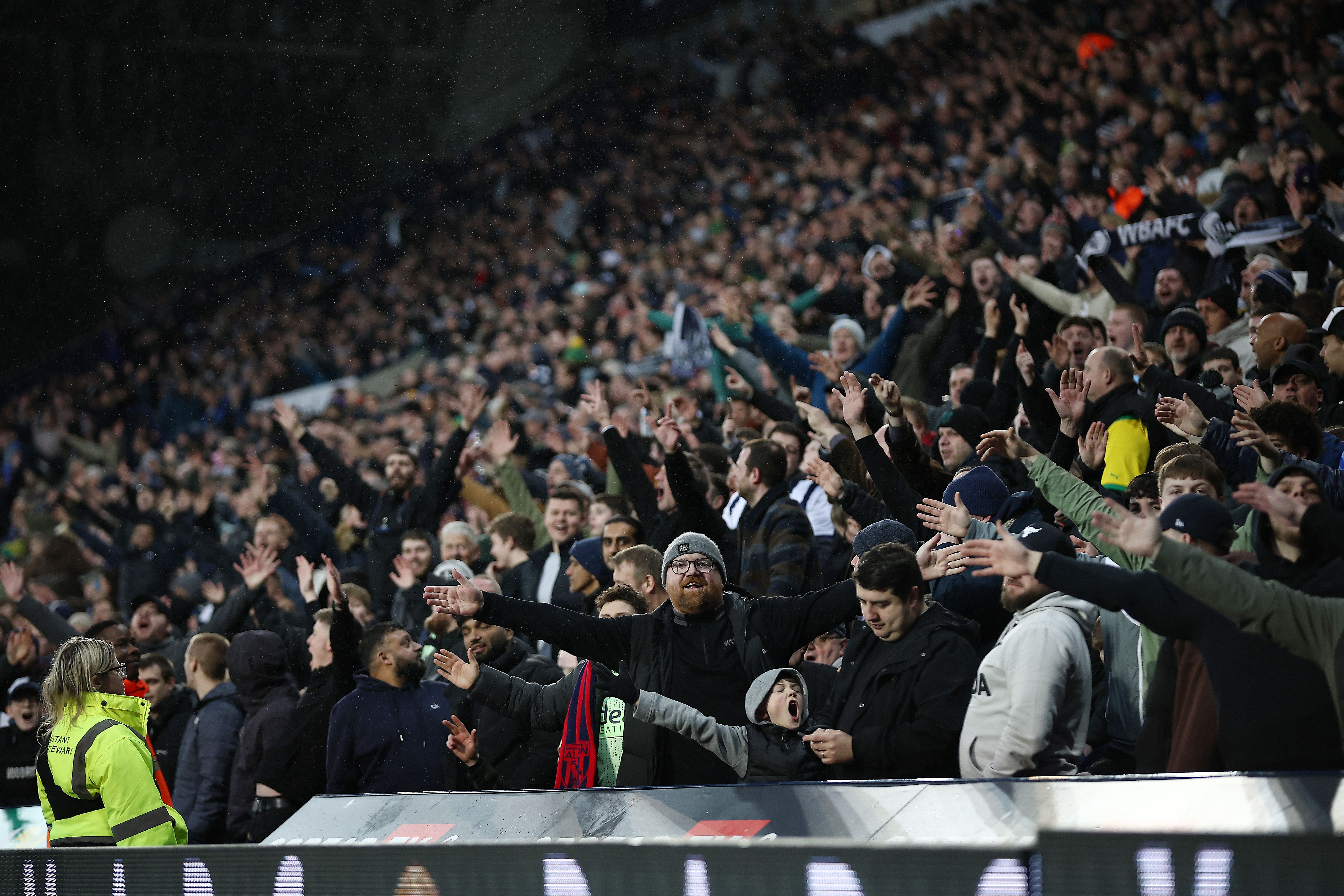 A general view of several Albion fans celebrating in the East Stand at a game 