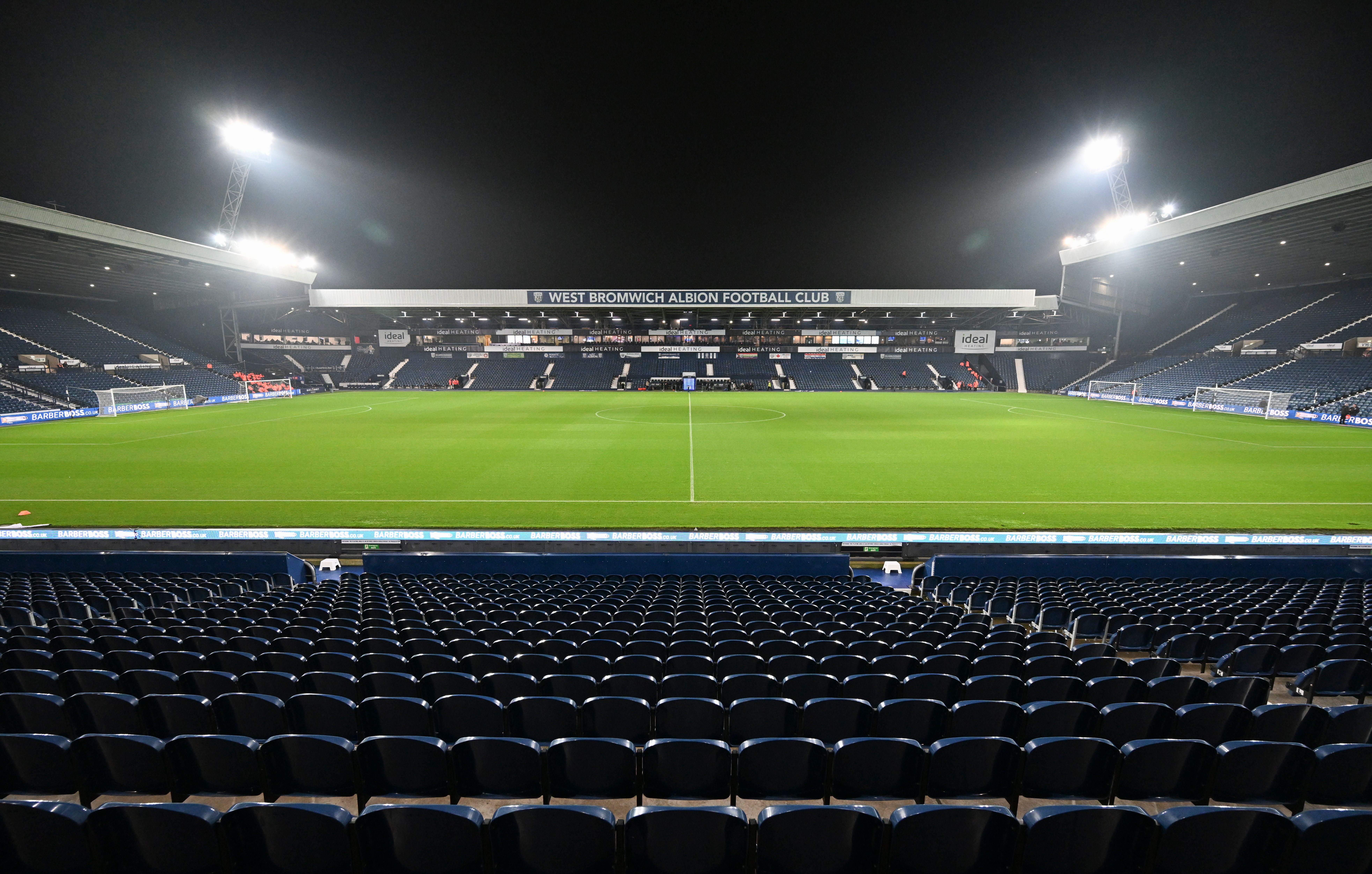 A general view of the West Stand at The Hawthorns at night with the floodlights on 