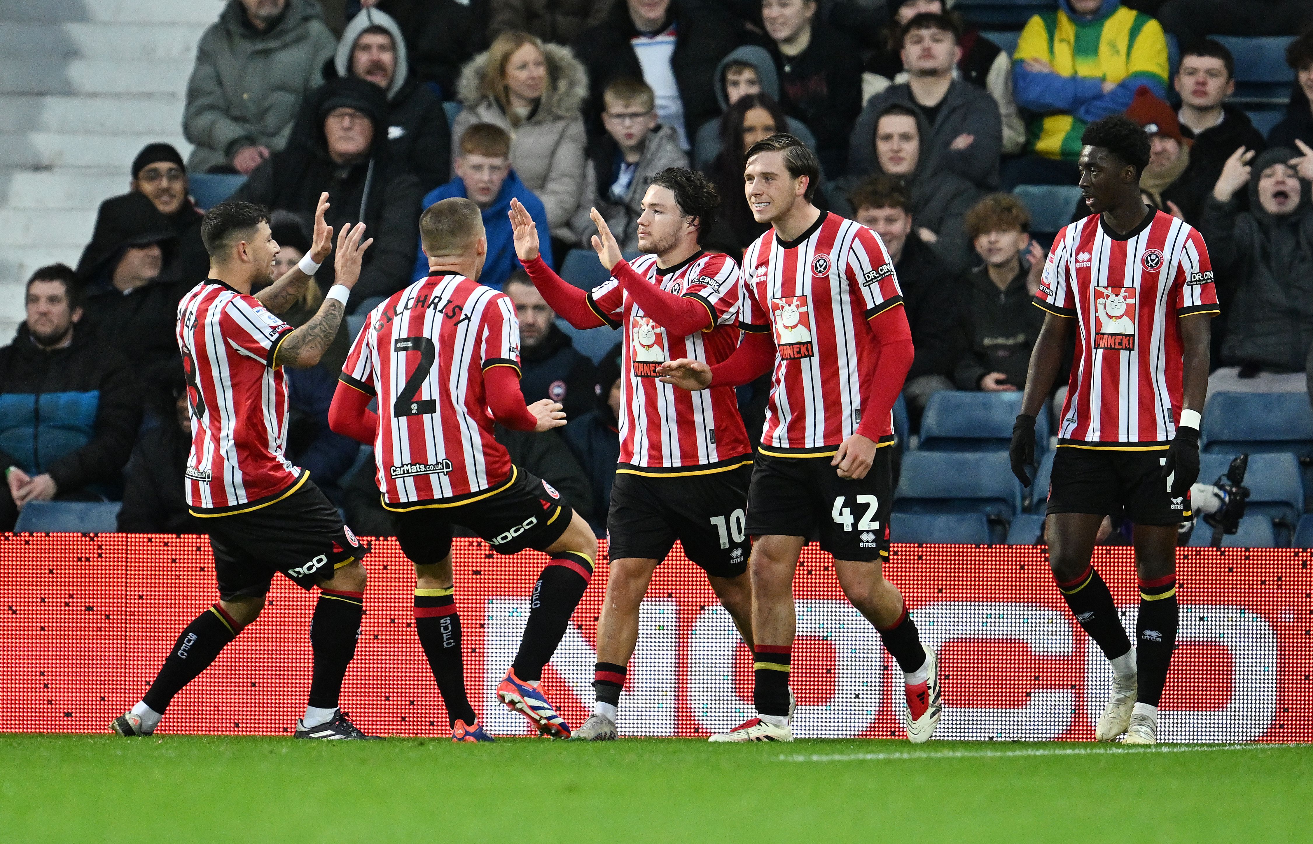 A general view of several Sheffield United players celebrating a goal in their home kit 