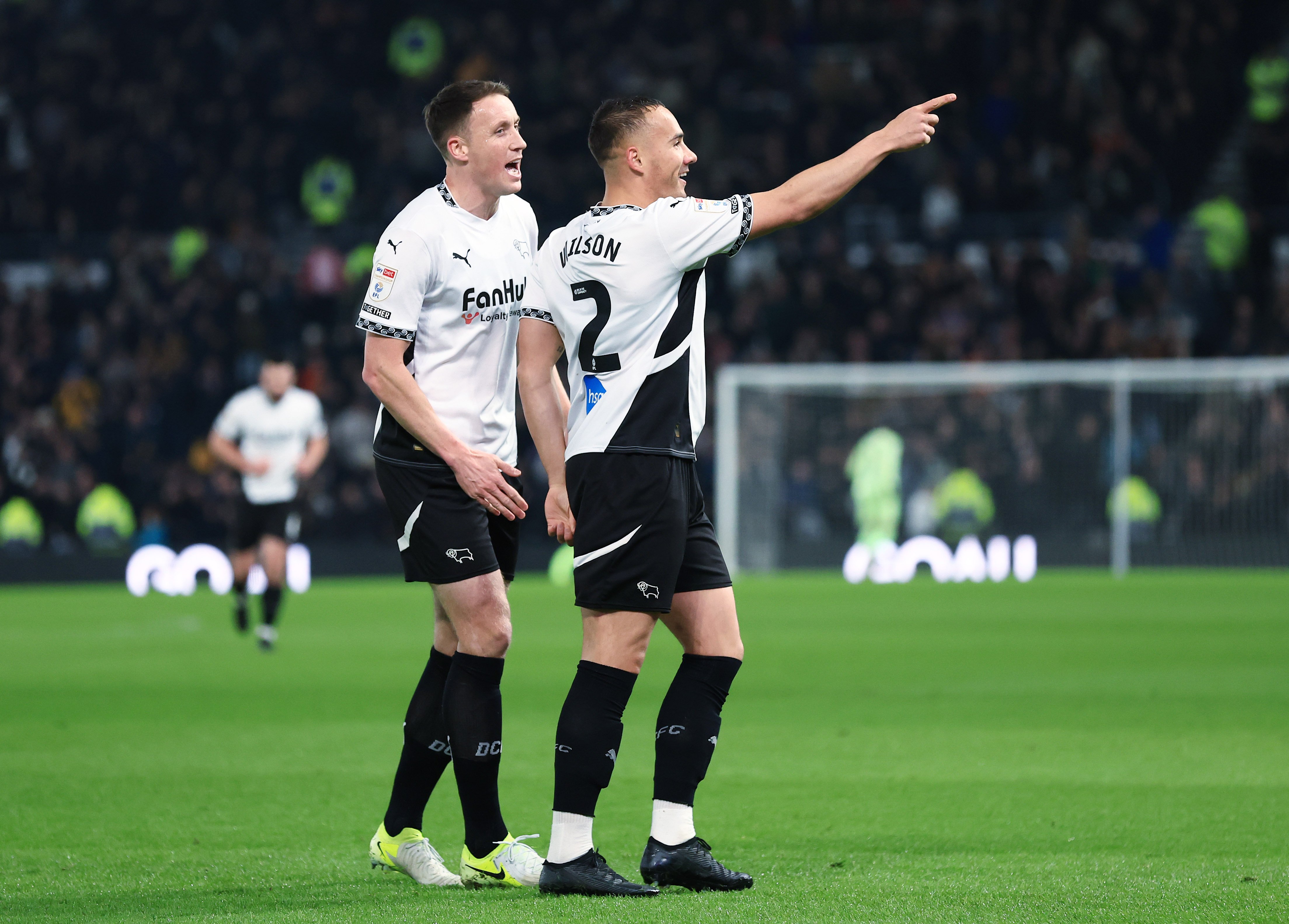 Kane Wilson celebrates scoring a goal for Derby County in their home kit 