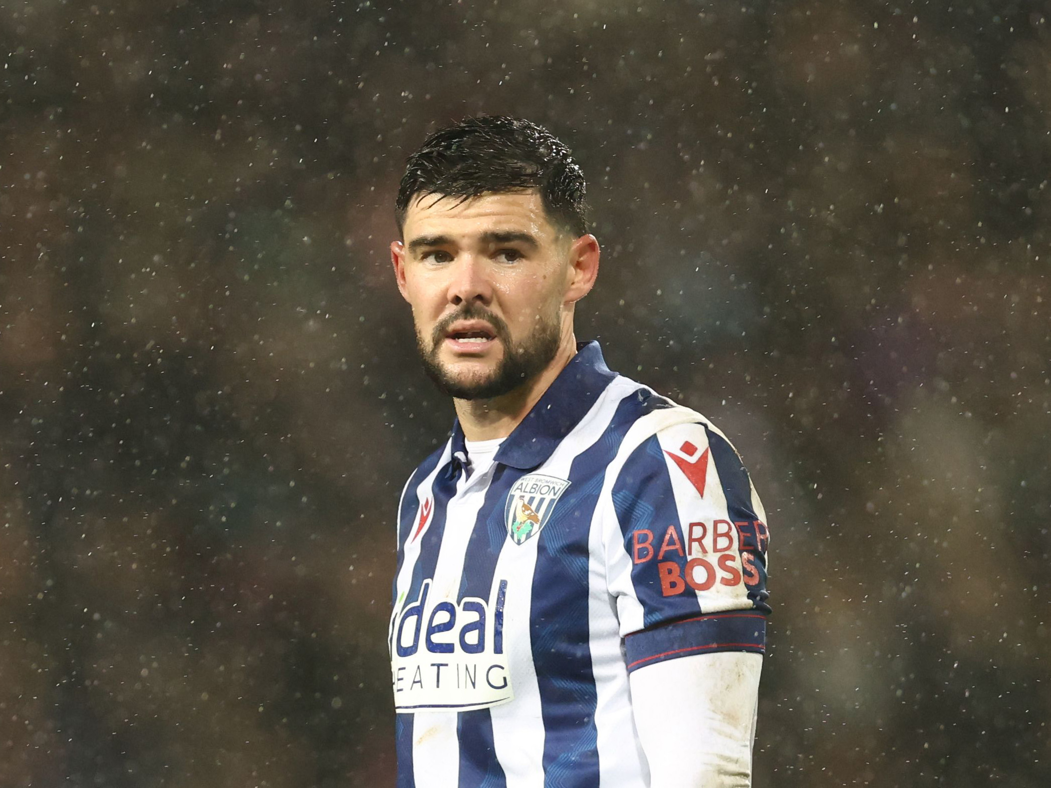 Alex Mowatt in action for Albion in the rain in the home shirt 