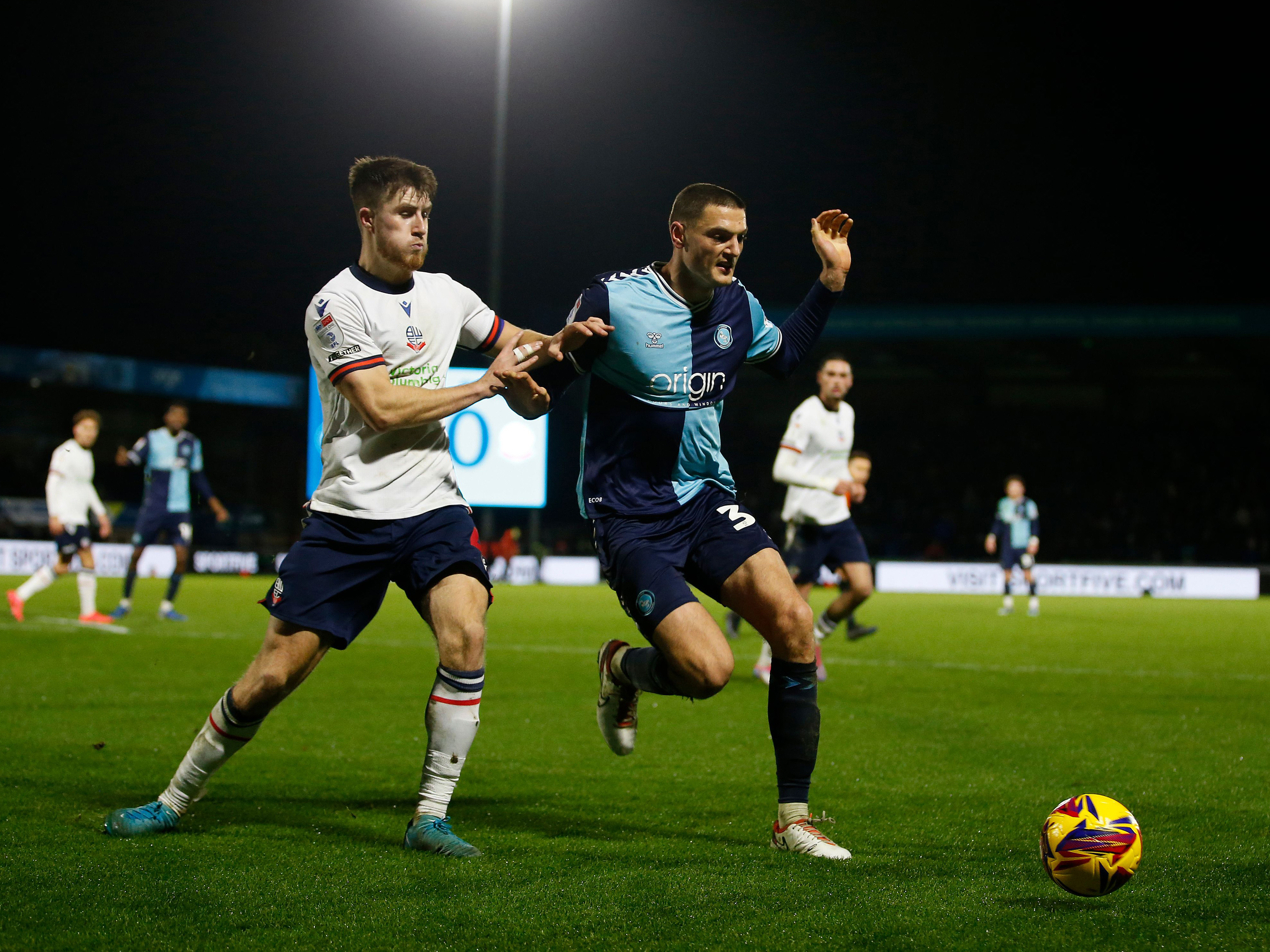 Caleb Taylor in action for Wycombe in their home kit against Bolton