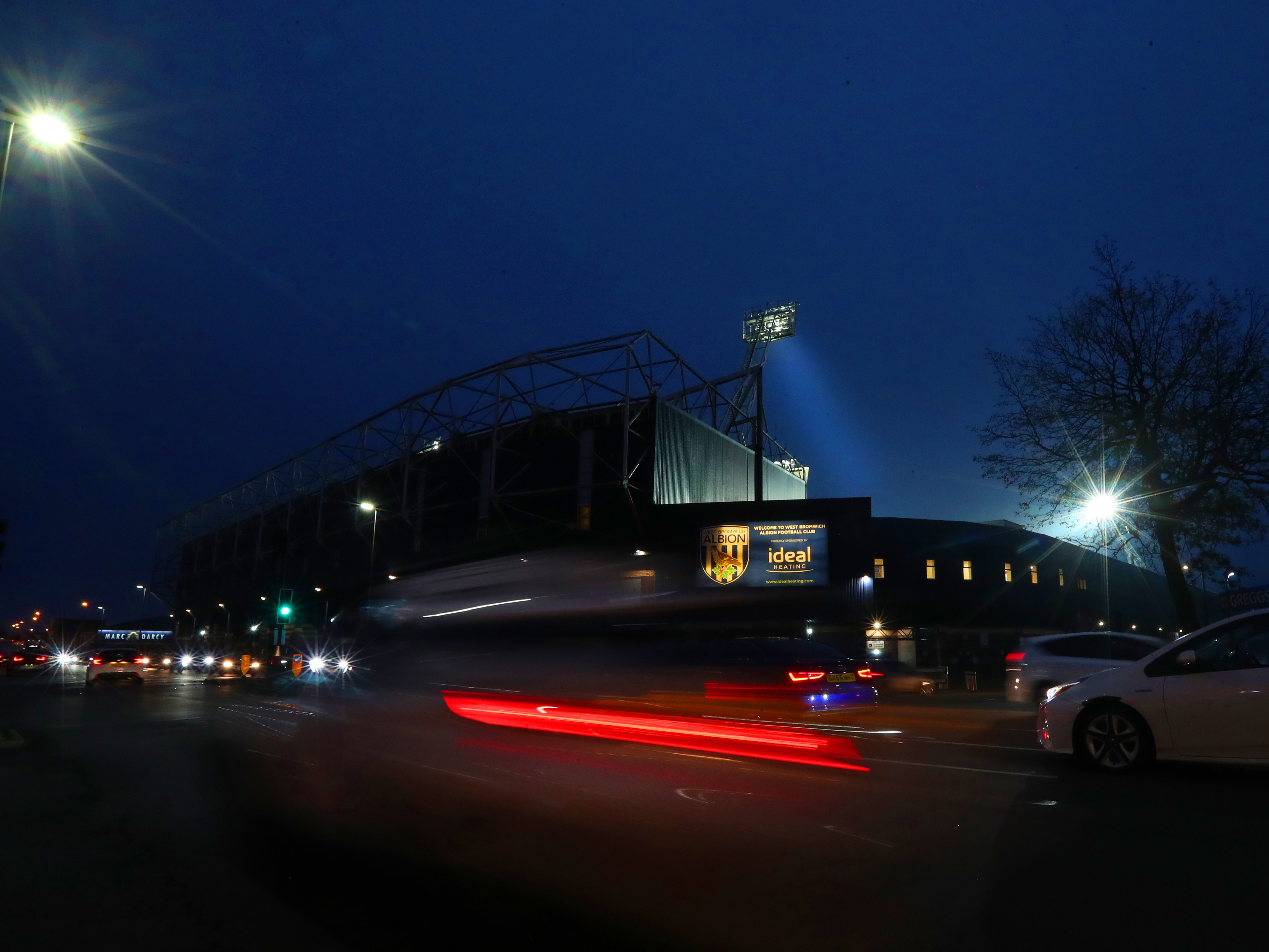 An image of The Hawthorns' Birmingham Road End from the outside at night