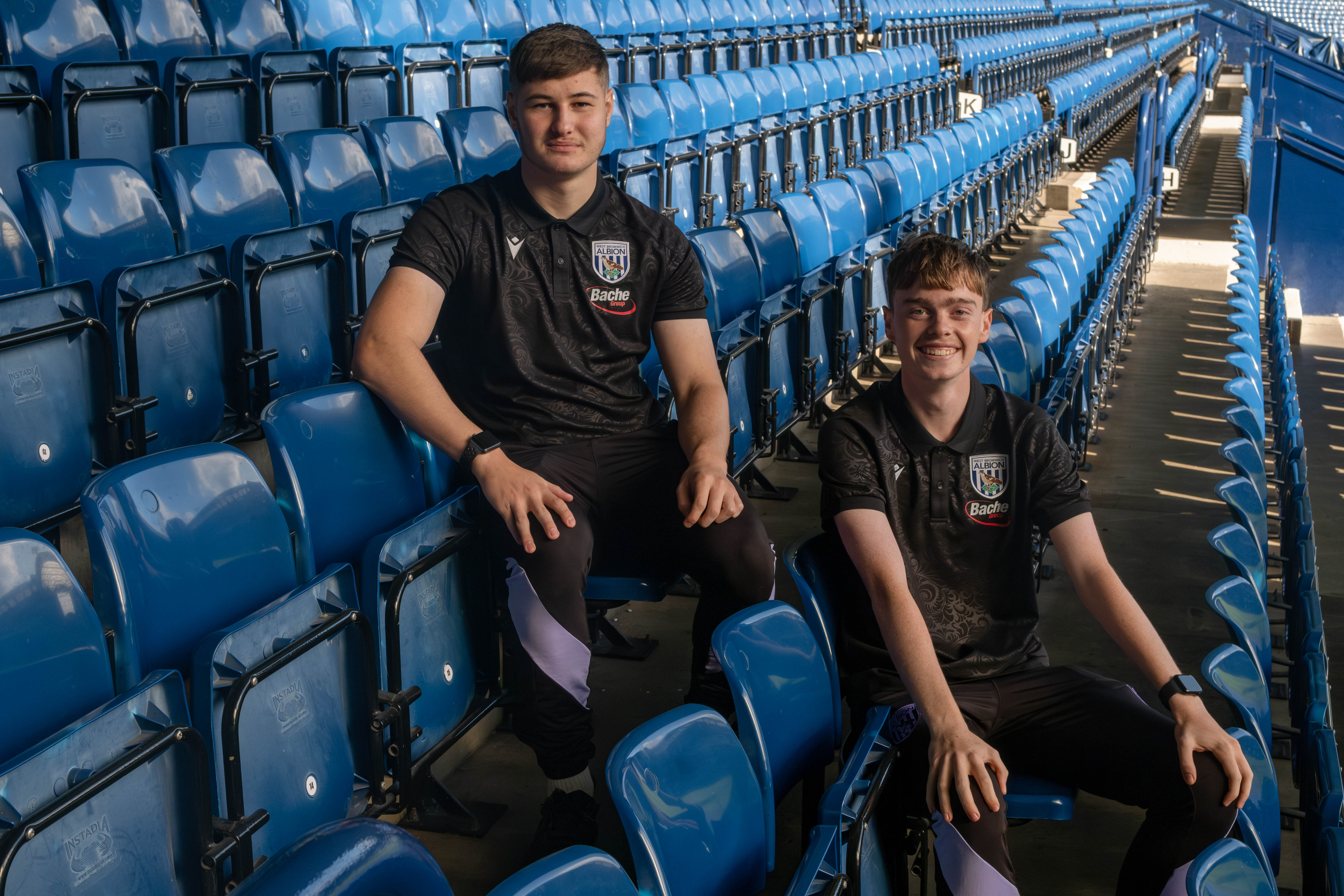 Brandon and Josh standing in the stands.