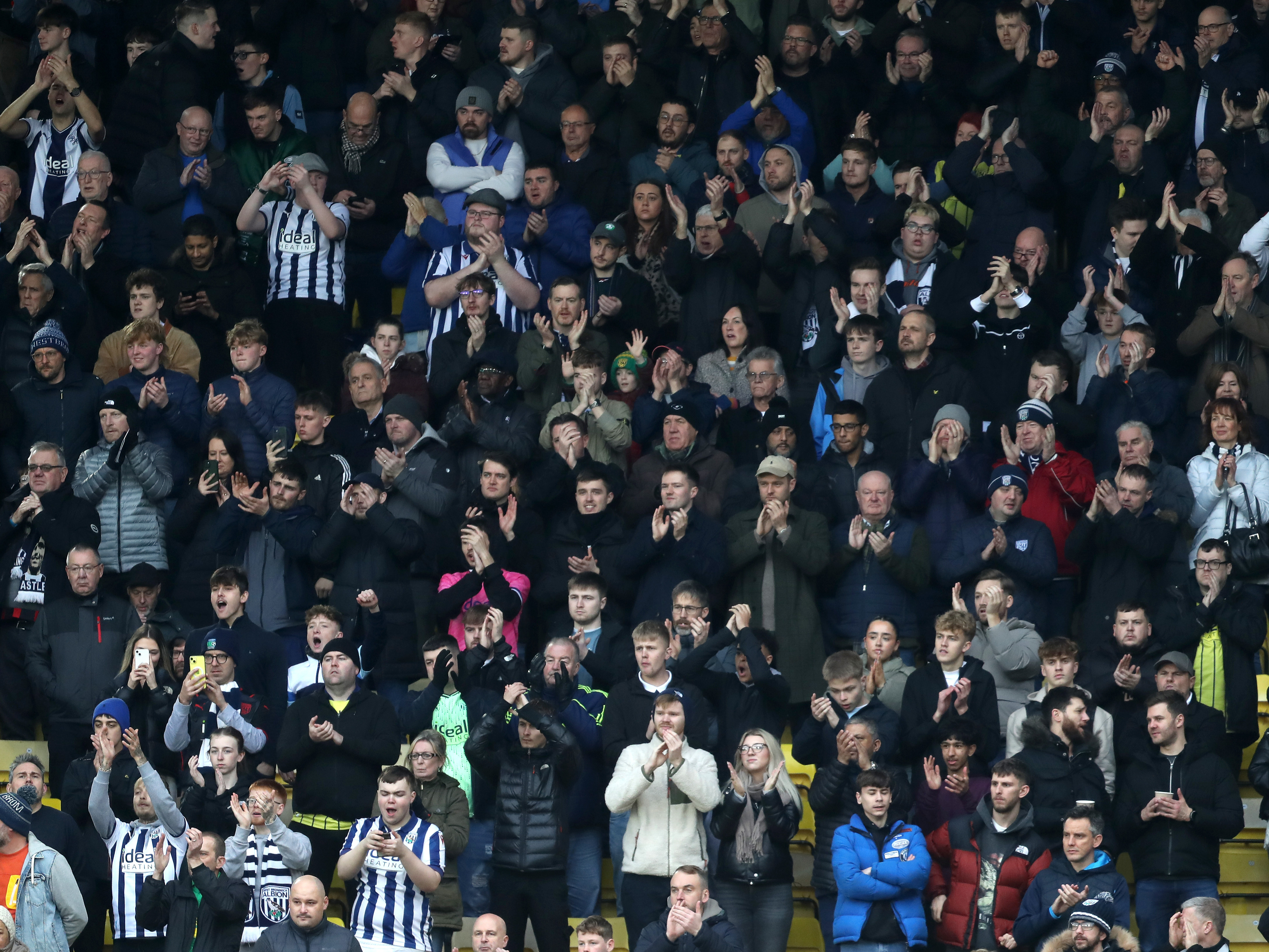 An image of Albion supporters applauding the team