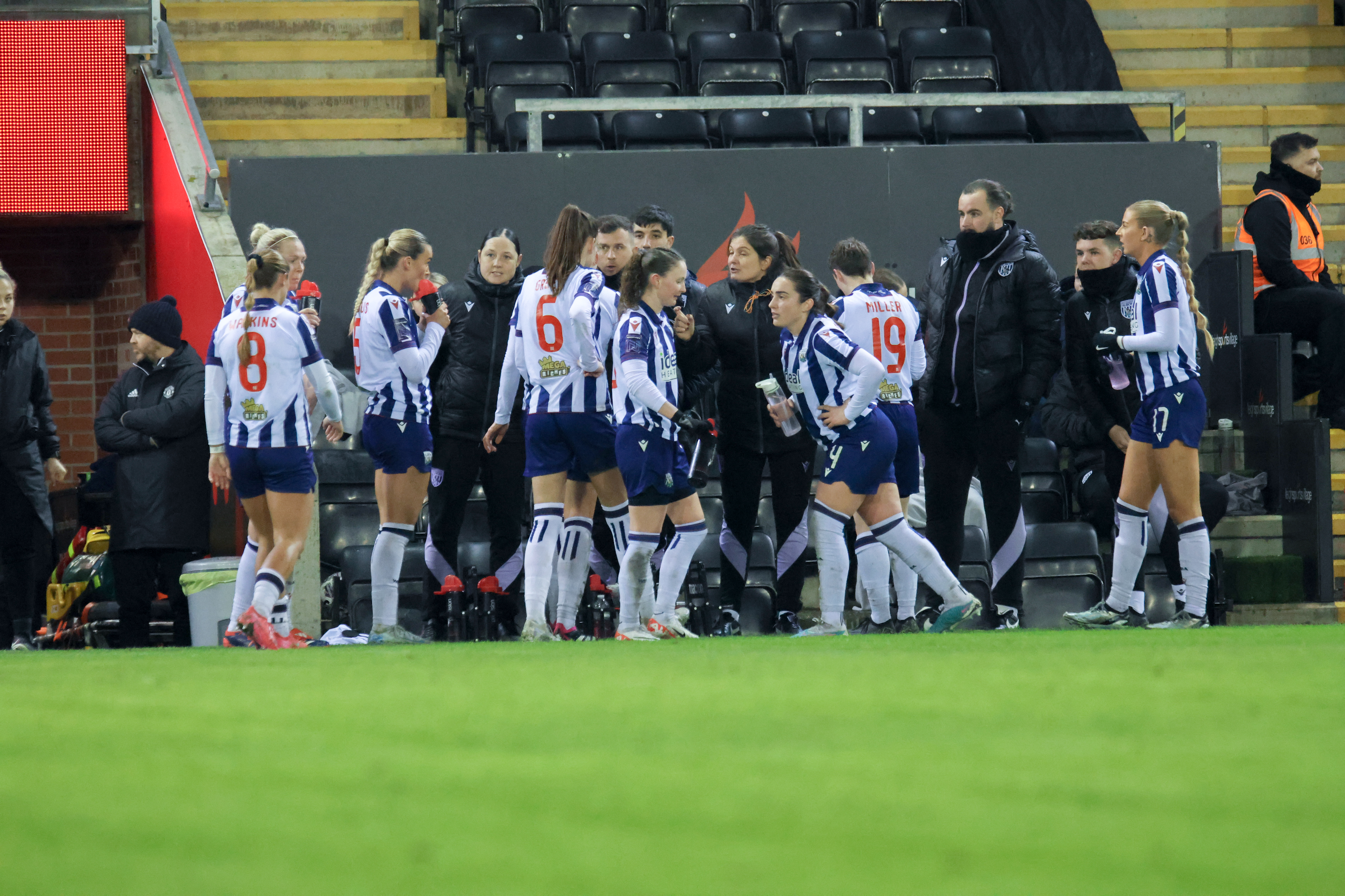 Siobhan Hodgetts-Still on the side of the pitch giving instructions to players during the Man United game