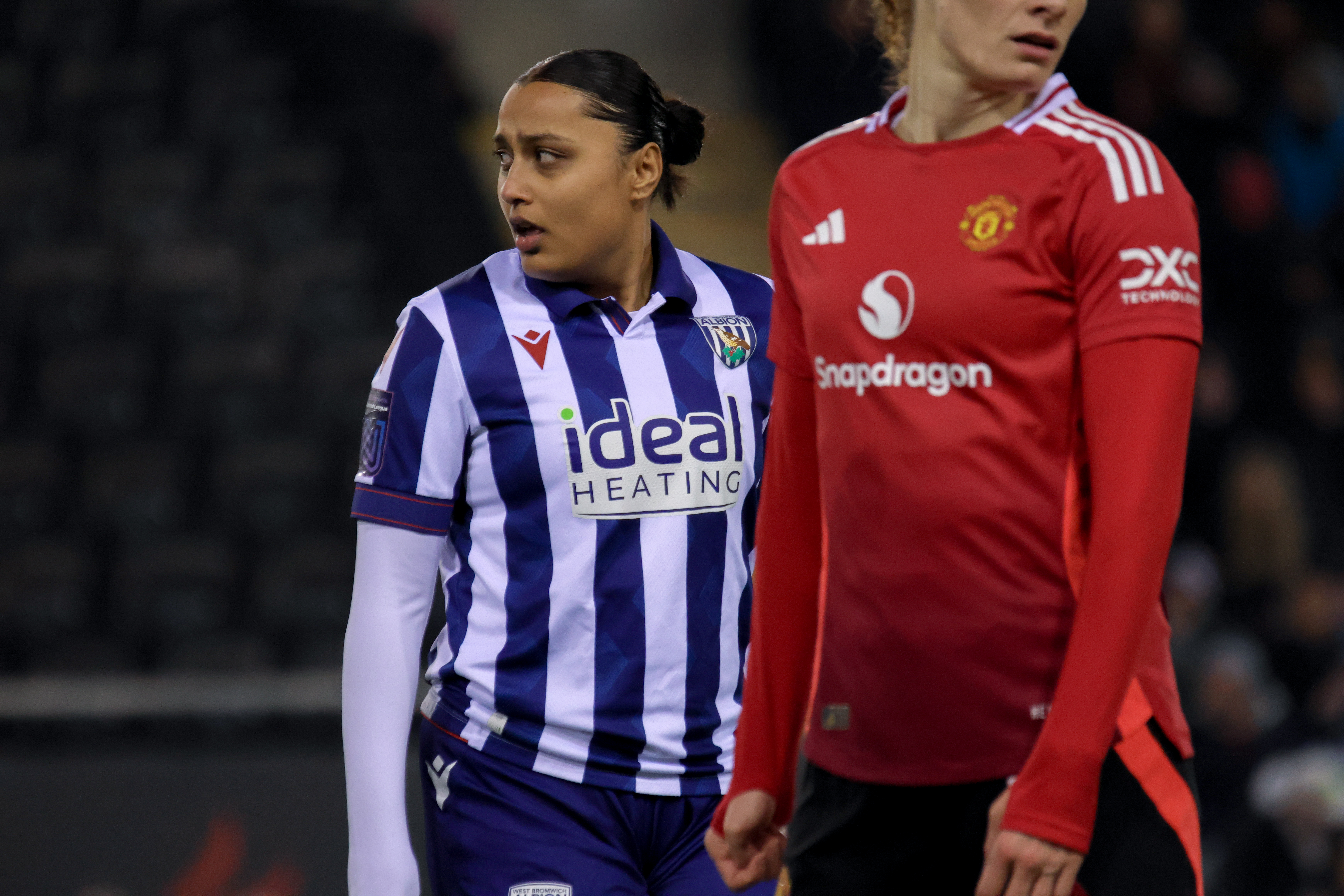 Simran Jhamat in action for Albion Women against Man United wearing the home kit 