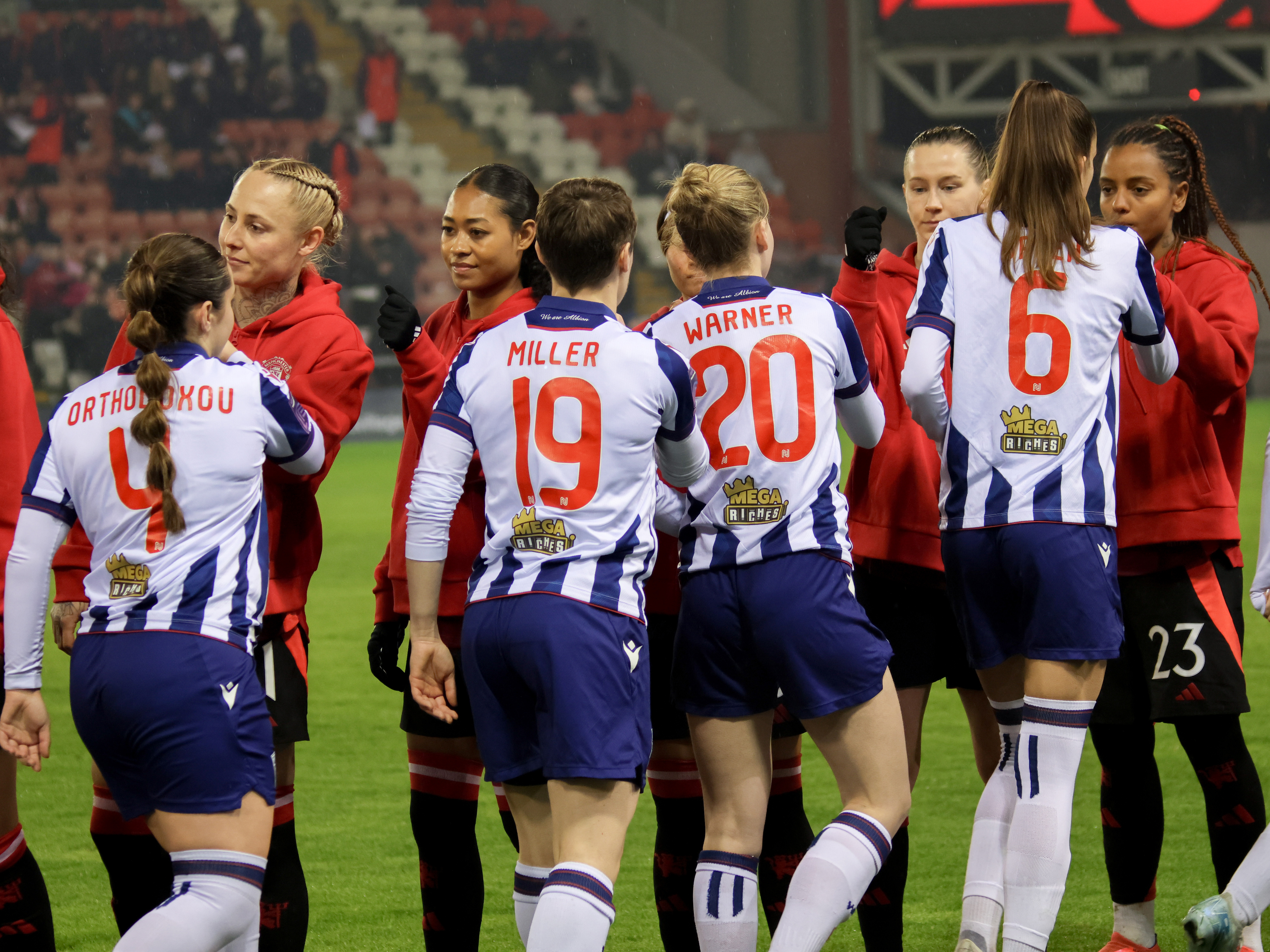 Albion Women shake hands with Man United players before the game