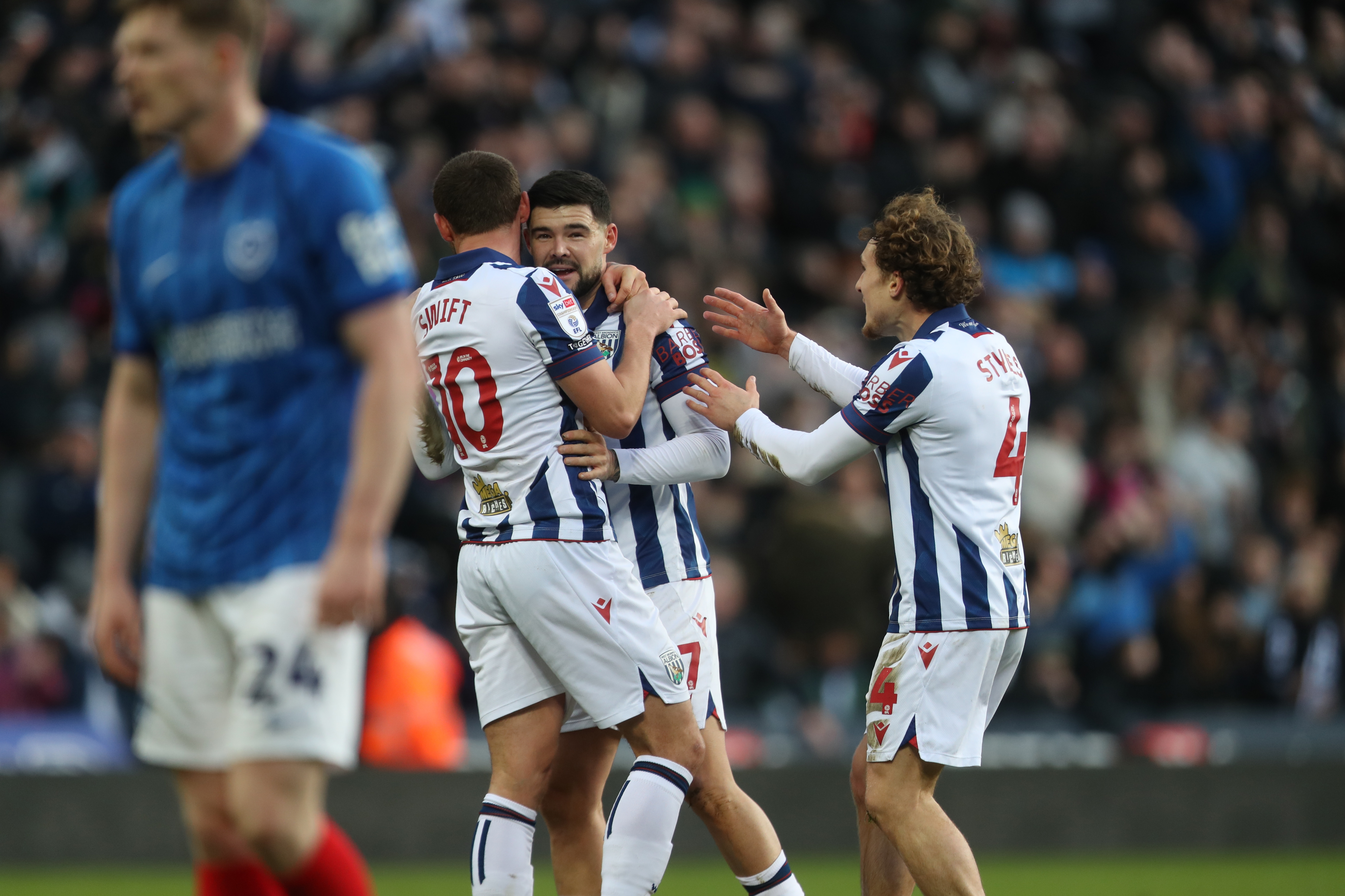 Alex Mowatt celebrates with John Swift and Callum Styles after scoring against Portsmouth