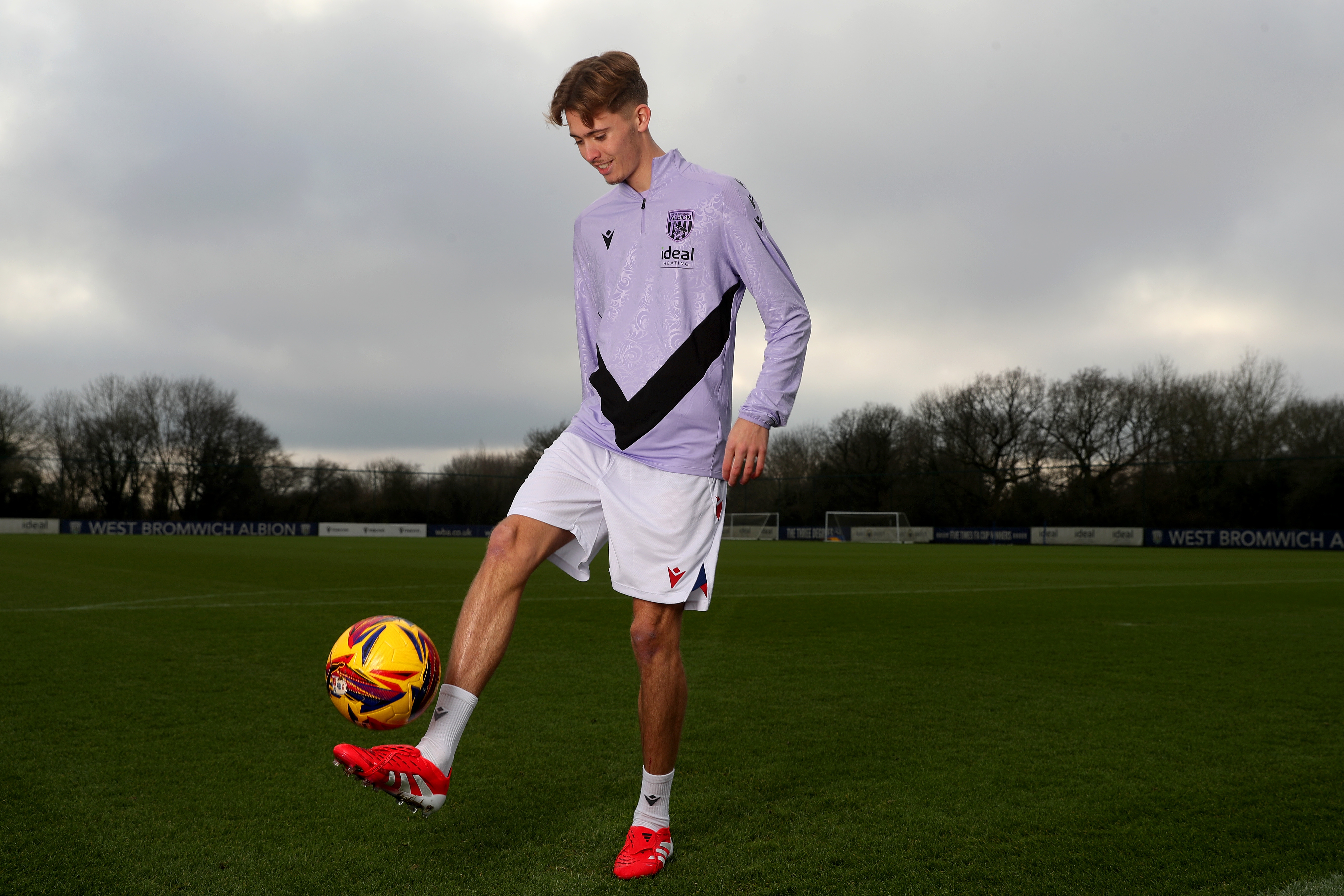 Isaac Price doing kick-ups with a yellow ball