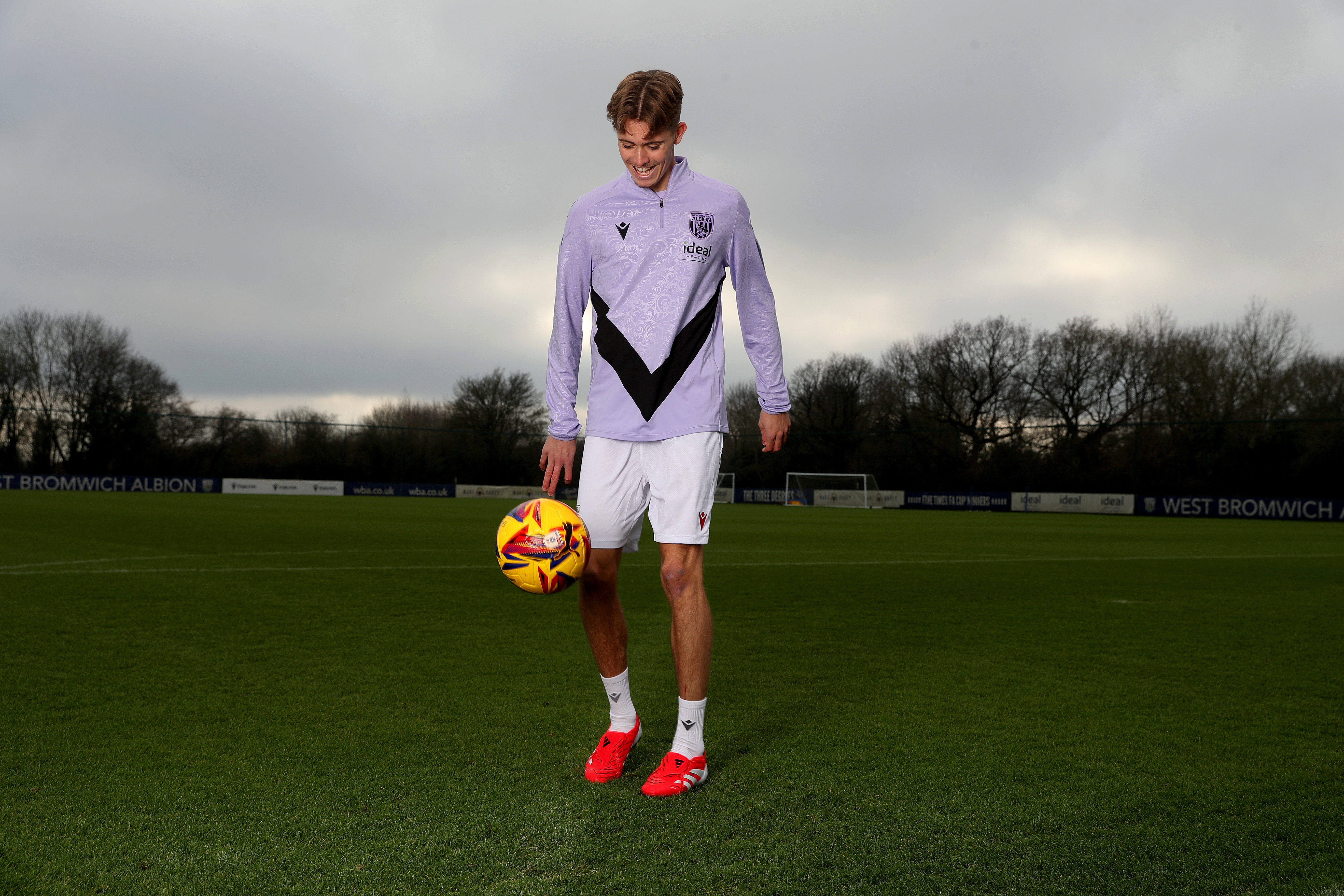 Isaac Price doing kick-ups with a yellow ball