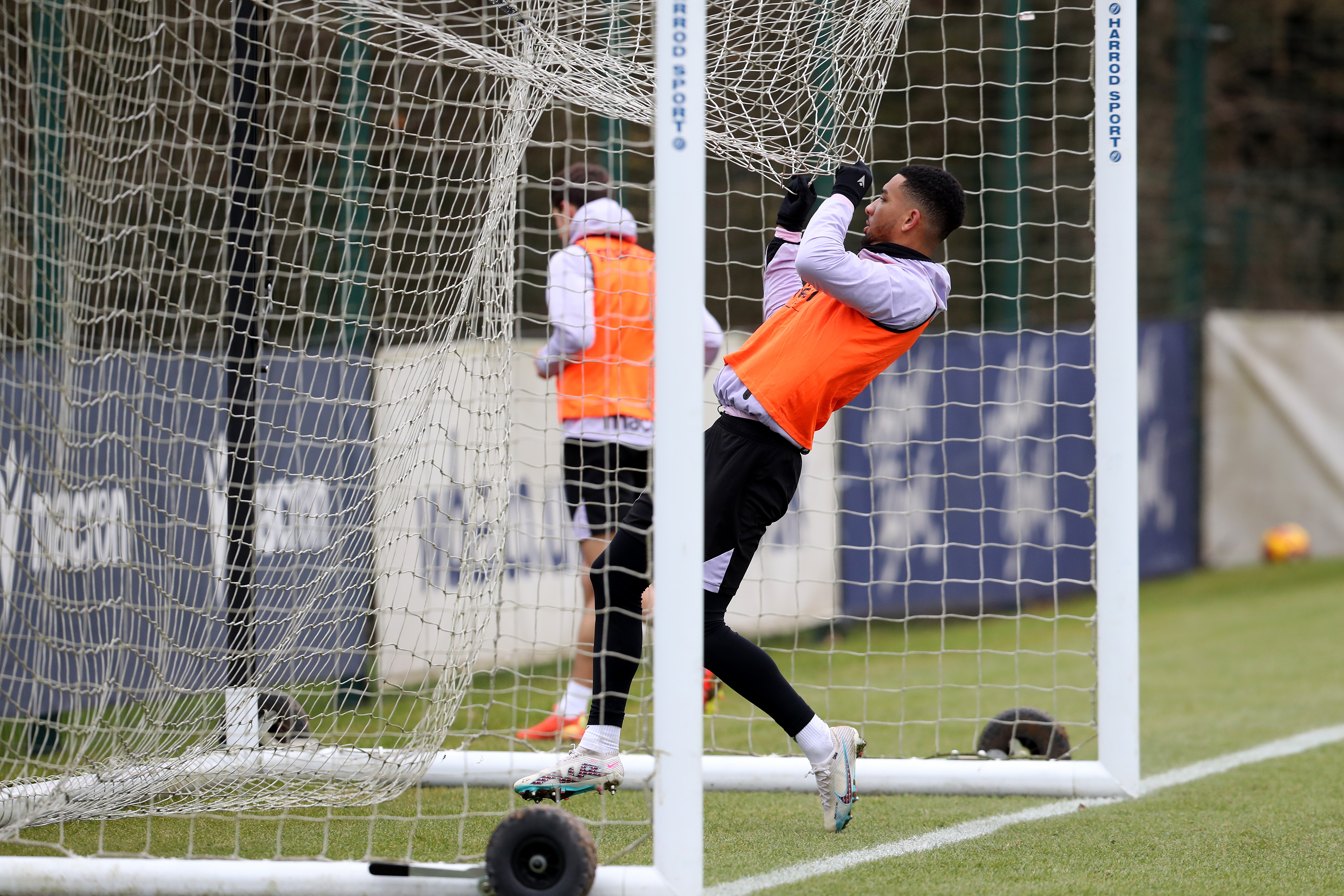 Mason Holgate hanging off a net during a training session