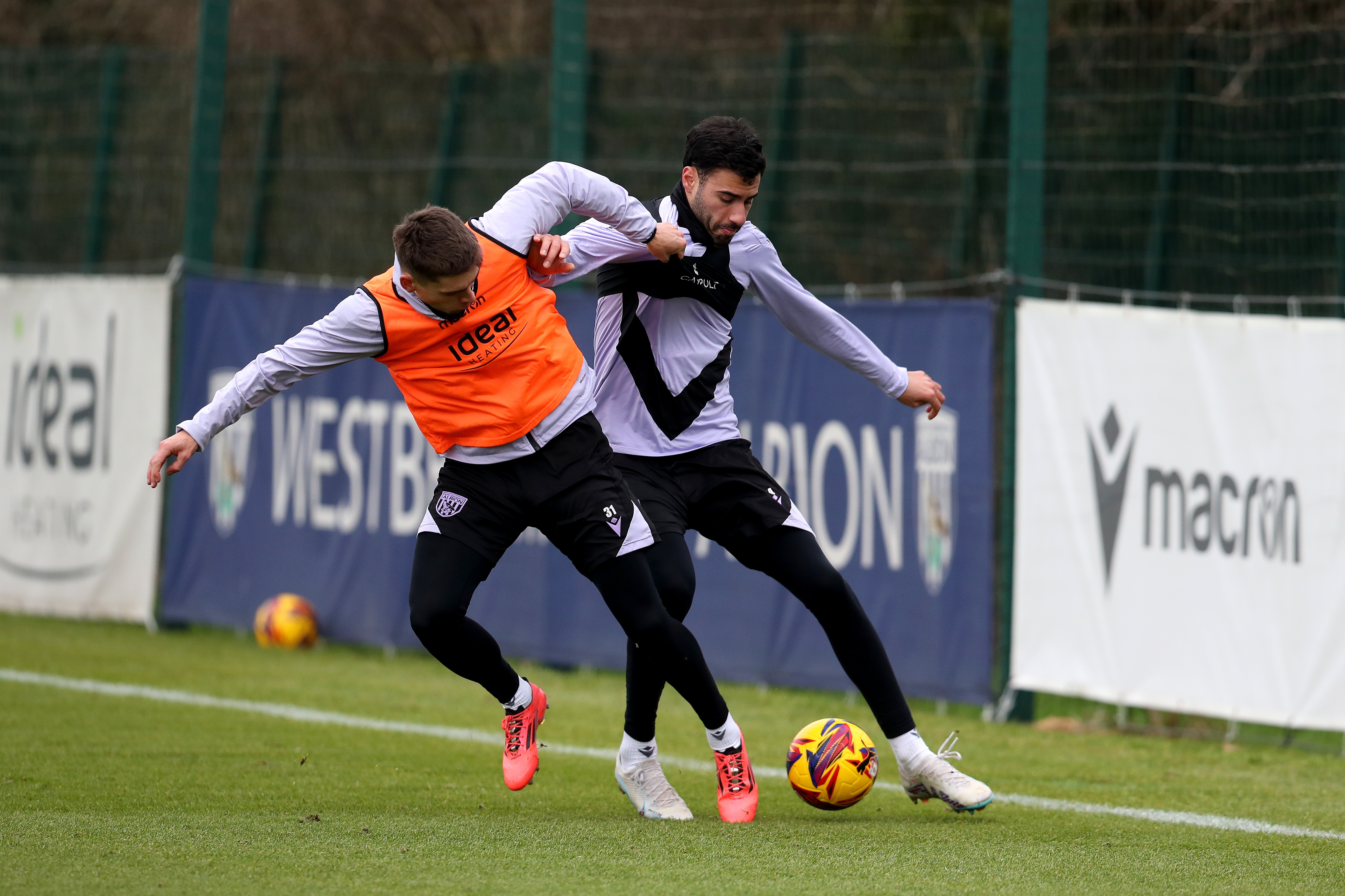 Tom Fellows and Gianluca Frabotta battling for the ball during a training session