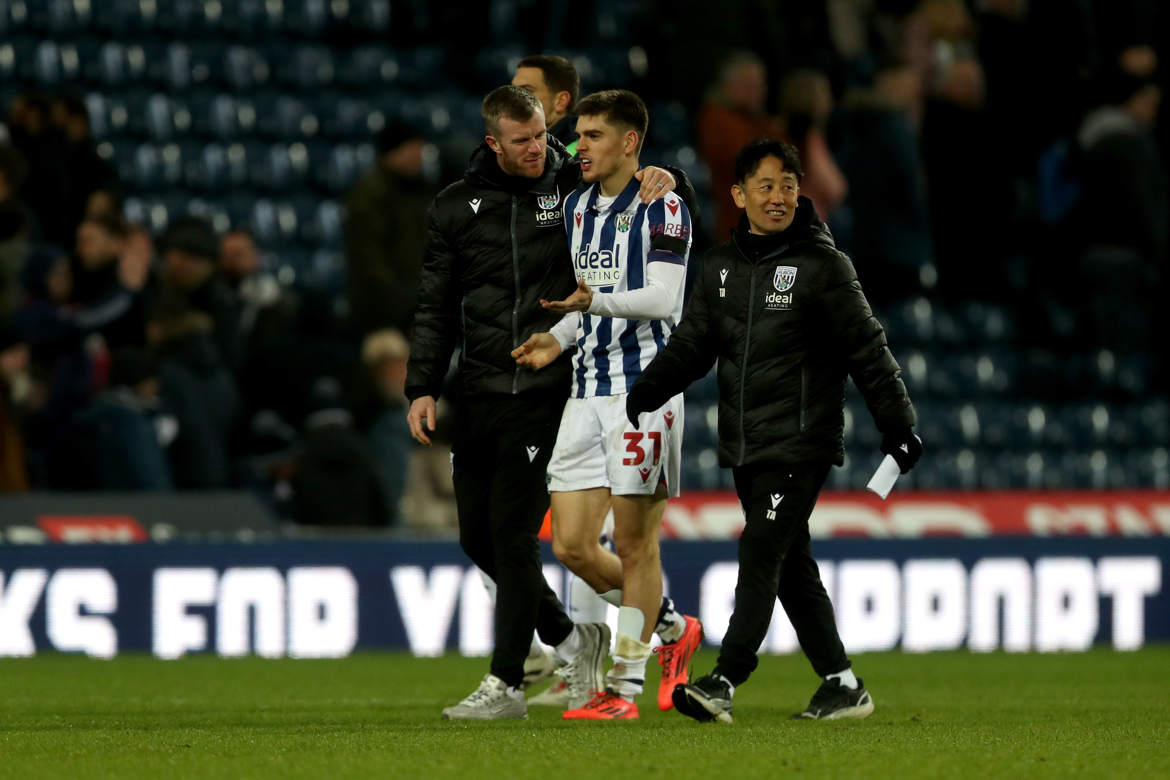 Chris Brunt with Tom Fellows at the end of Albion's game with Stoke