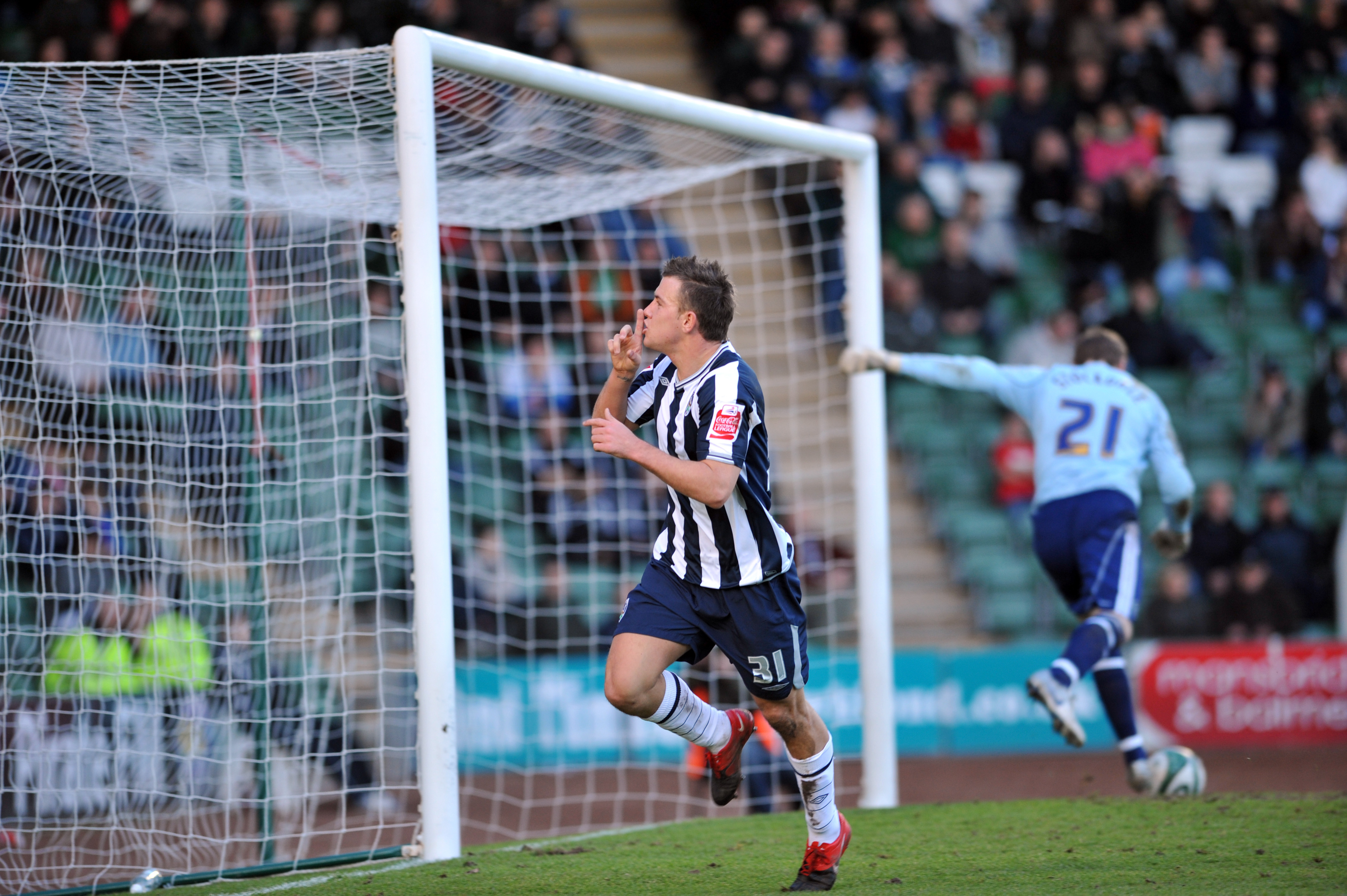 Simon Cox celebrates scoring at Plymouth in February 2010