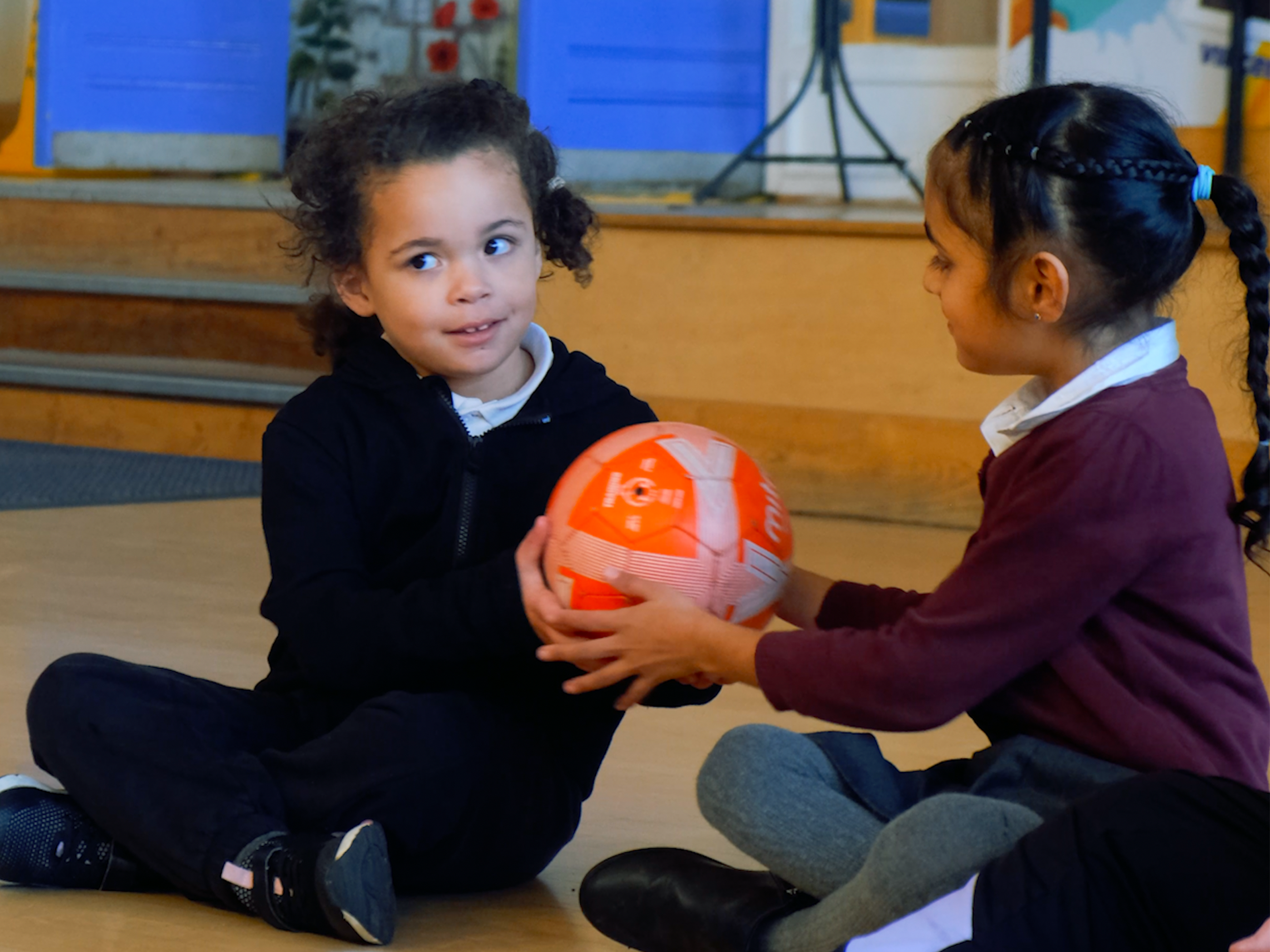 Early Years pupil Candice shares with another pupil.