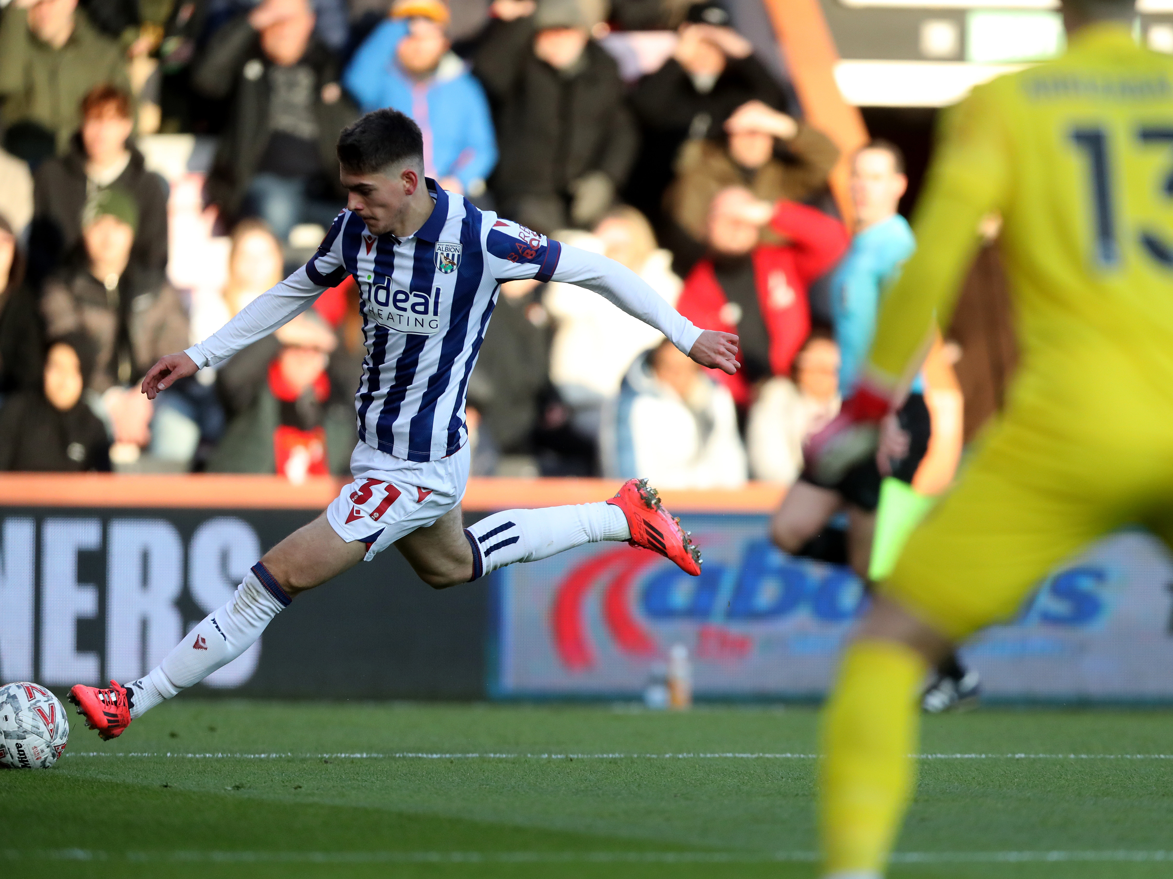 An image of Tom Fellows crossing the ball