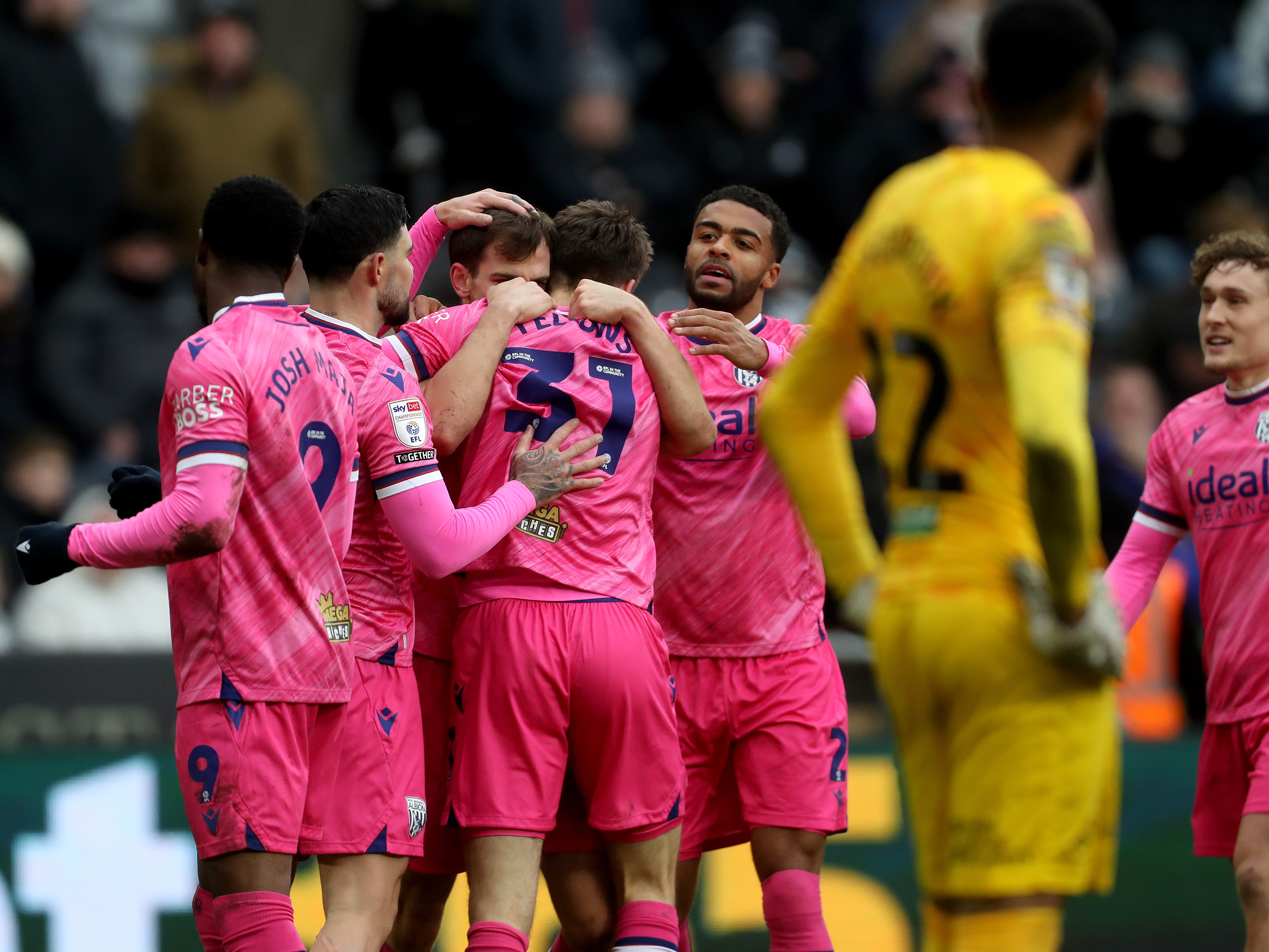 An image of Tom Fellows celebrating his goal against Swansea with his teammates