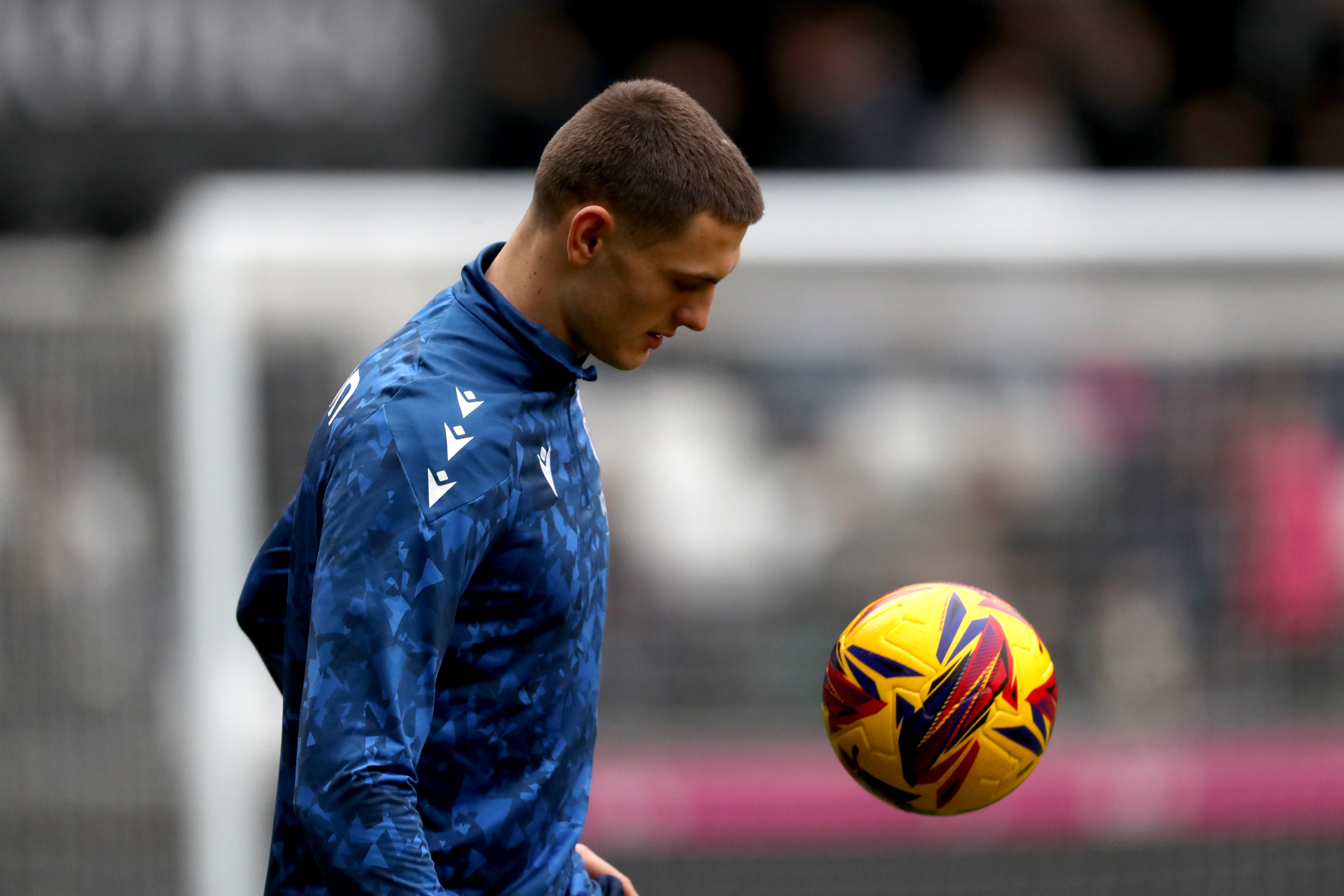 Caleb Taylor looking at a ball while warming up