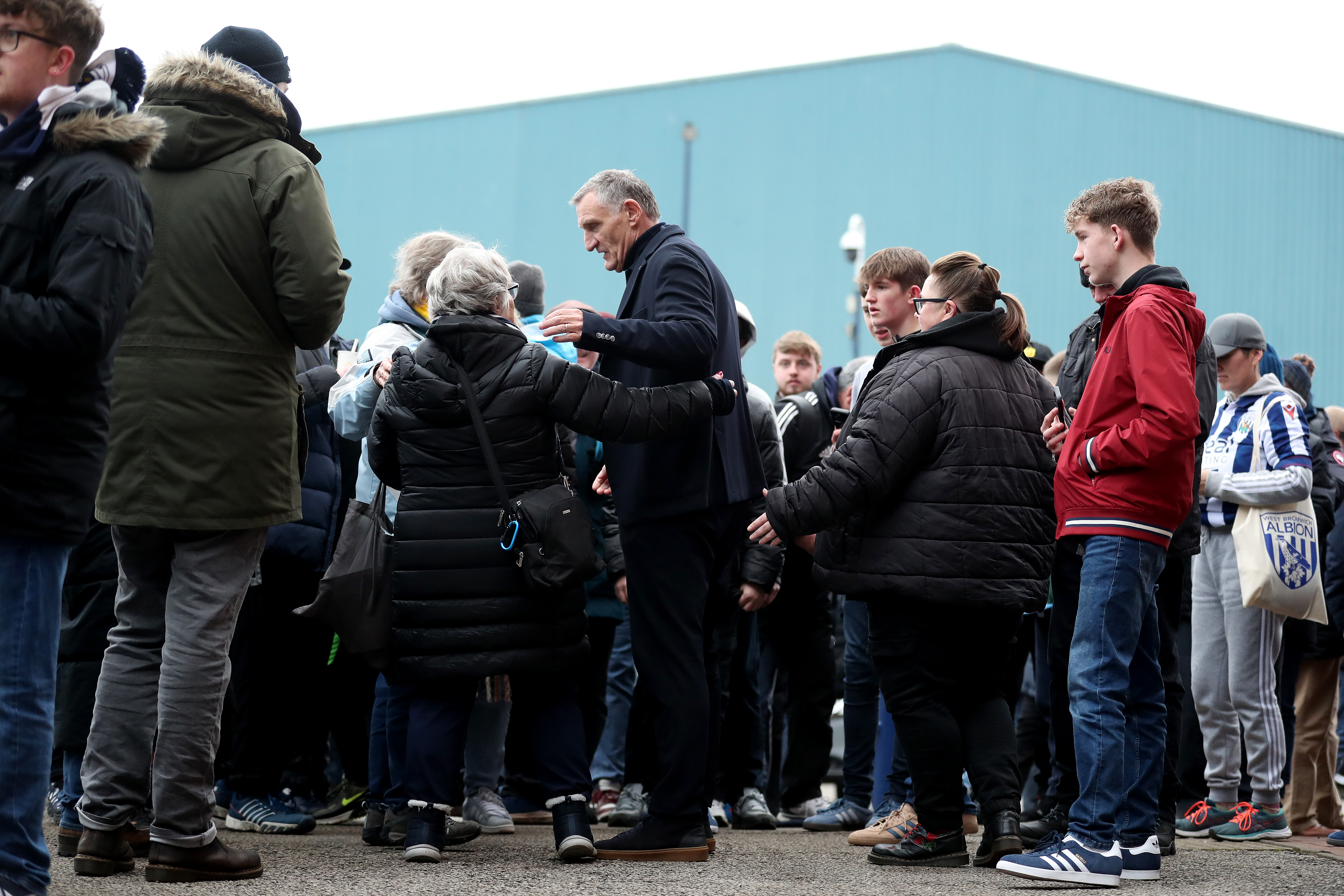 Tony Mowbray surrounded by Albion fans outside The Hawthorns