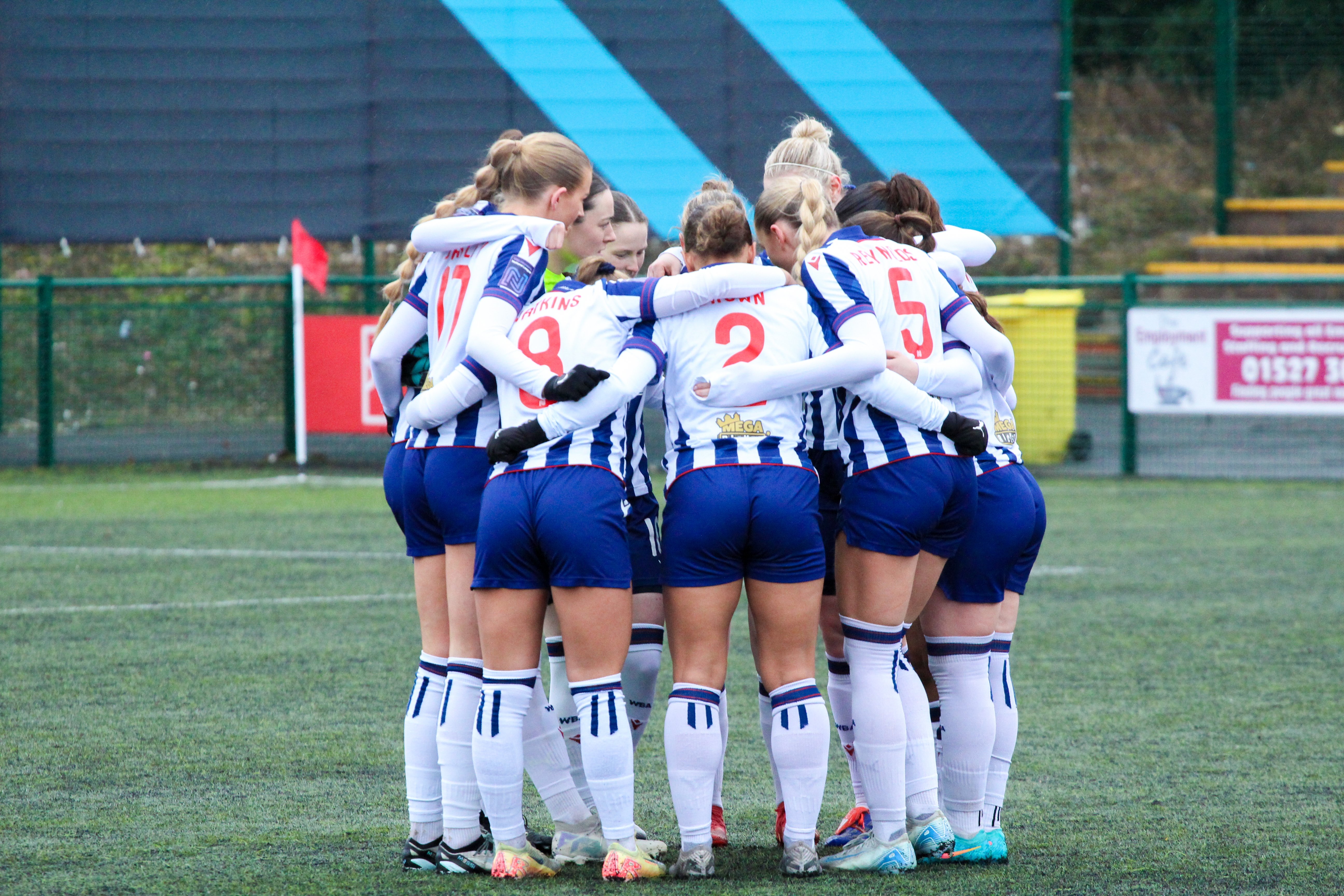 Albion Women in a team huddle.