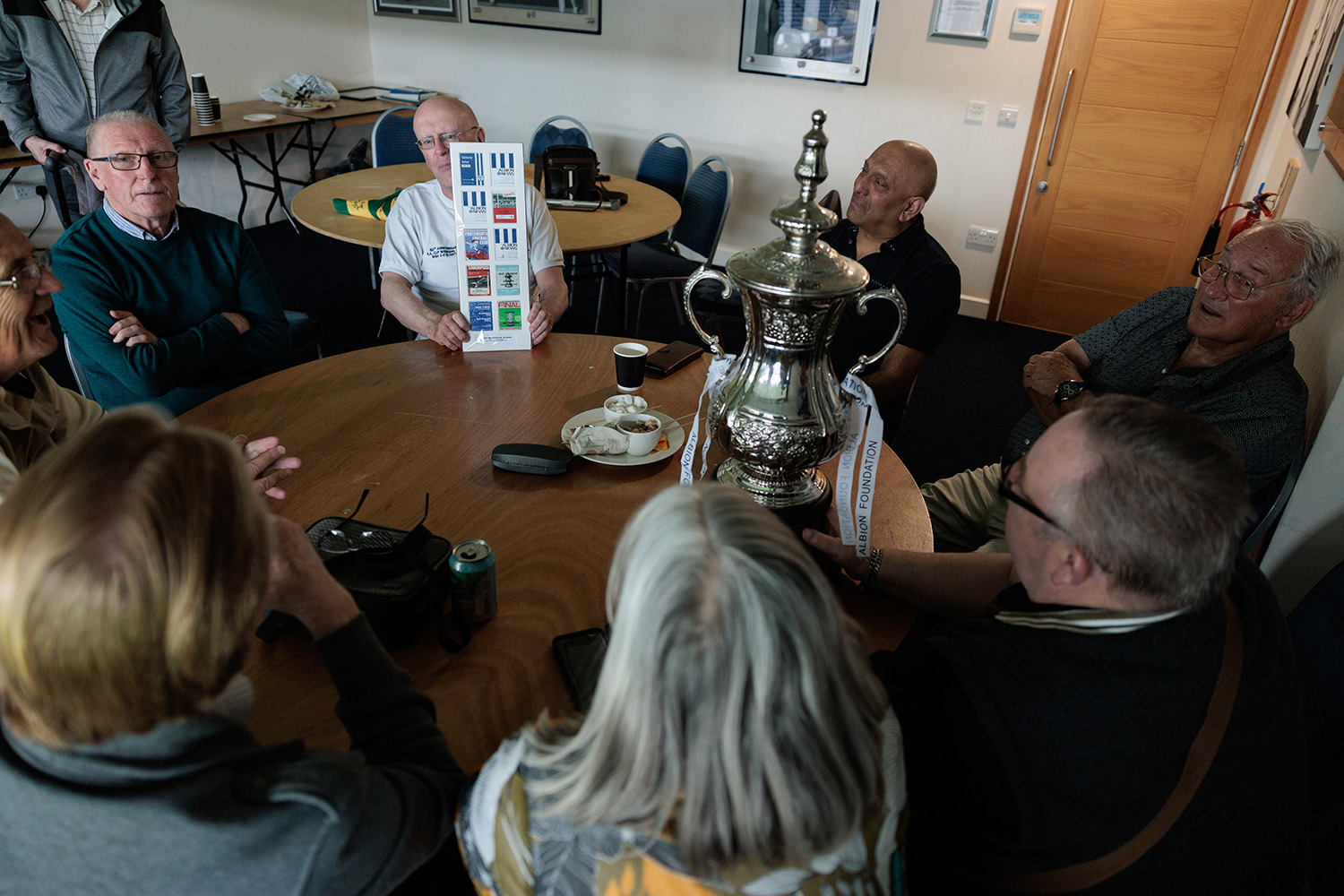 Memories Group in discussion with replicate FA Cup on the table.