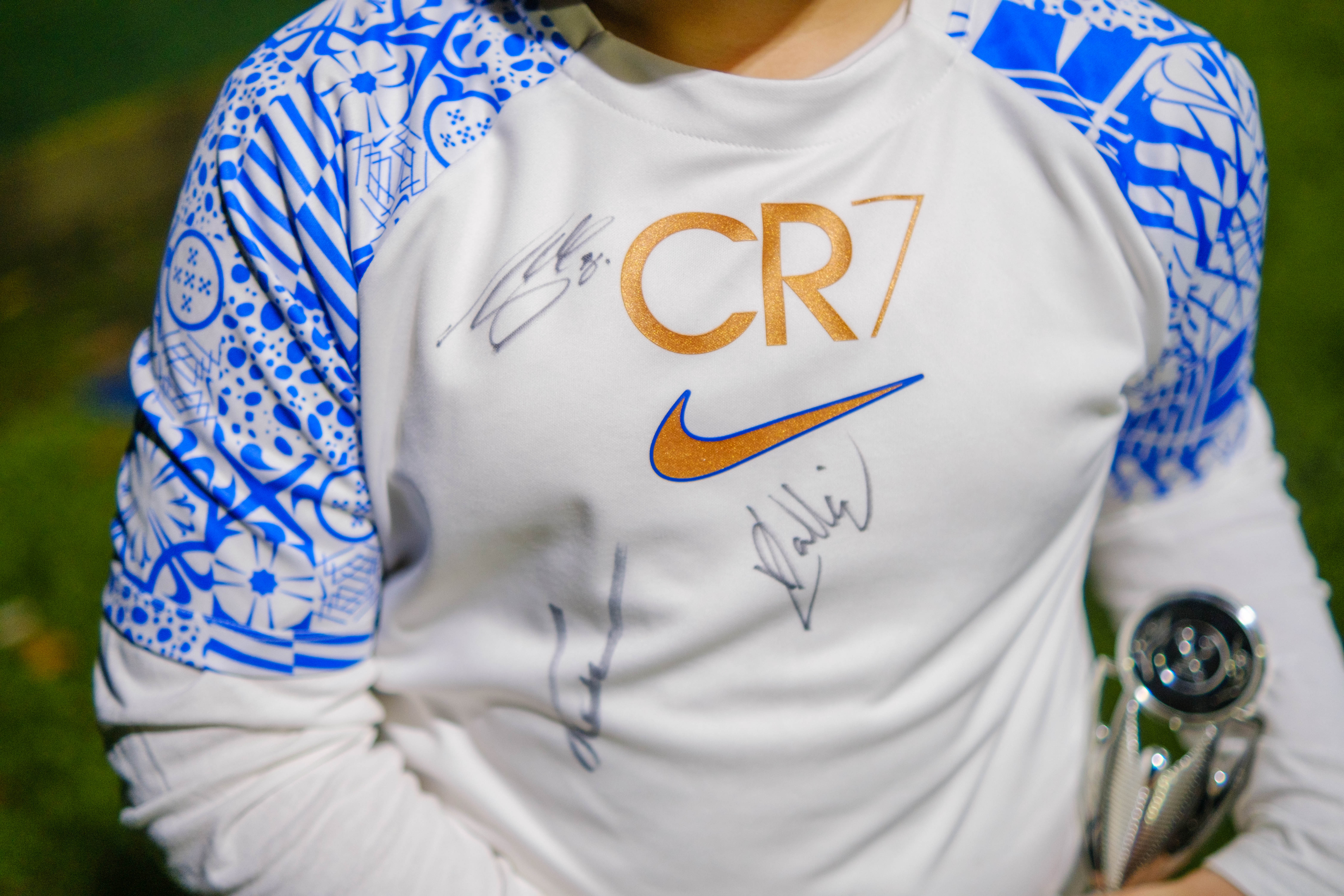 Cezar's training top, signed by Jayson Molumby, Ted Cann and Lewis Dobbin.