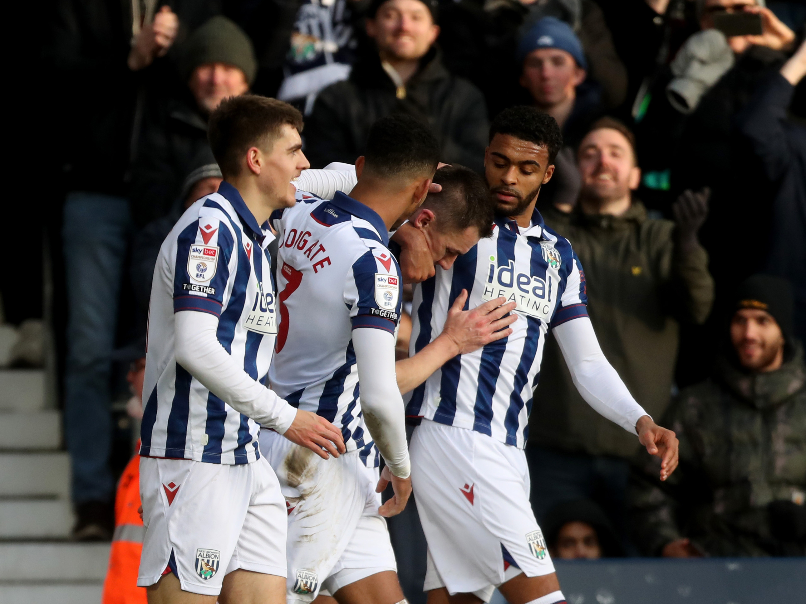 Albion players celebrate in the home kit after scoring a goal against Portsmouth 