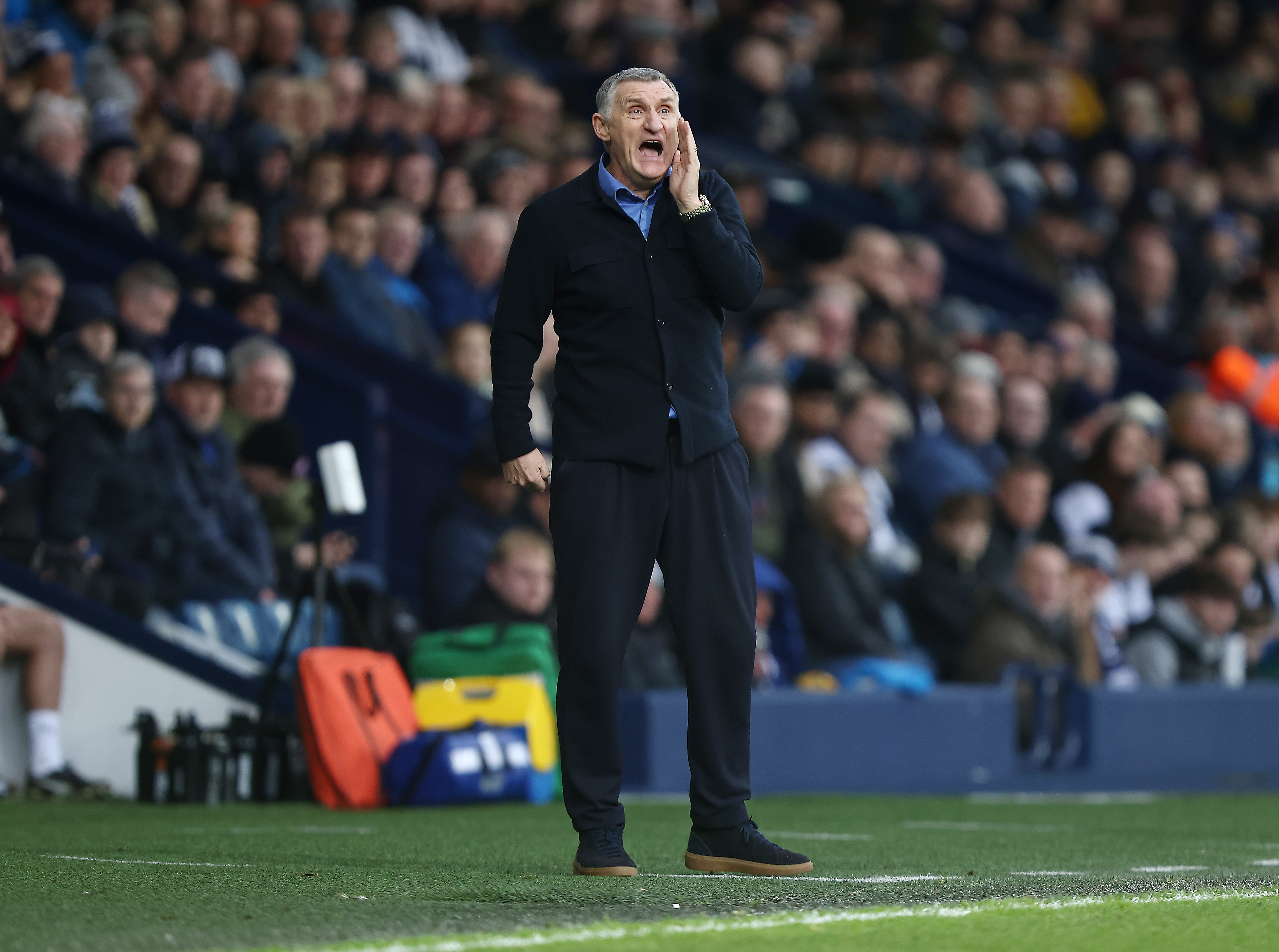 Tony Mowbray standing on the side of the pitch shouting 