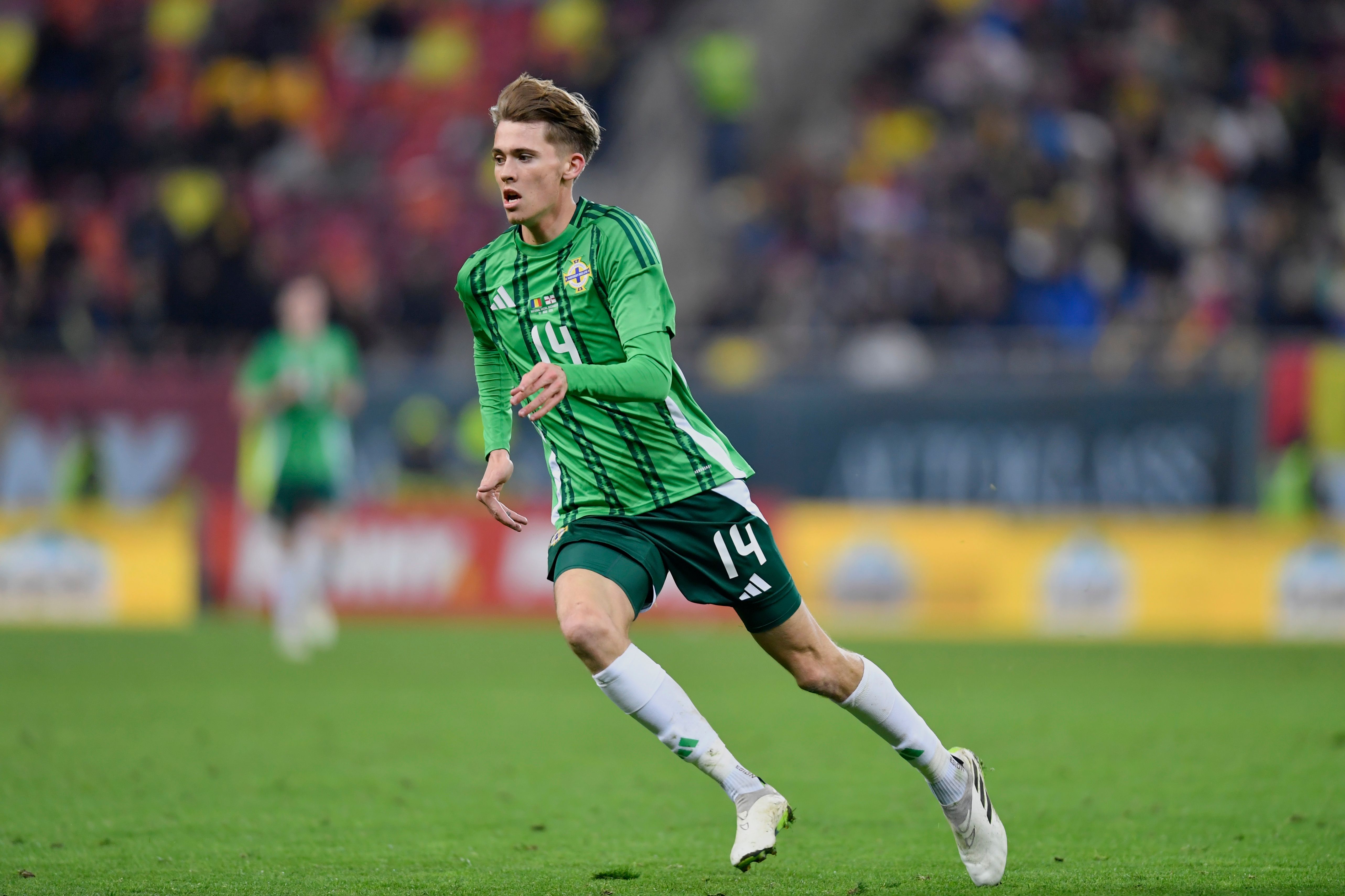 Isaac Price in action for Northern Ireland in their home kit 