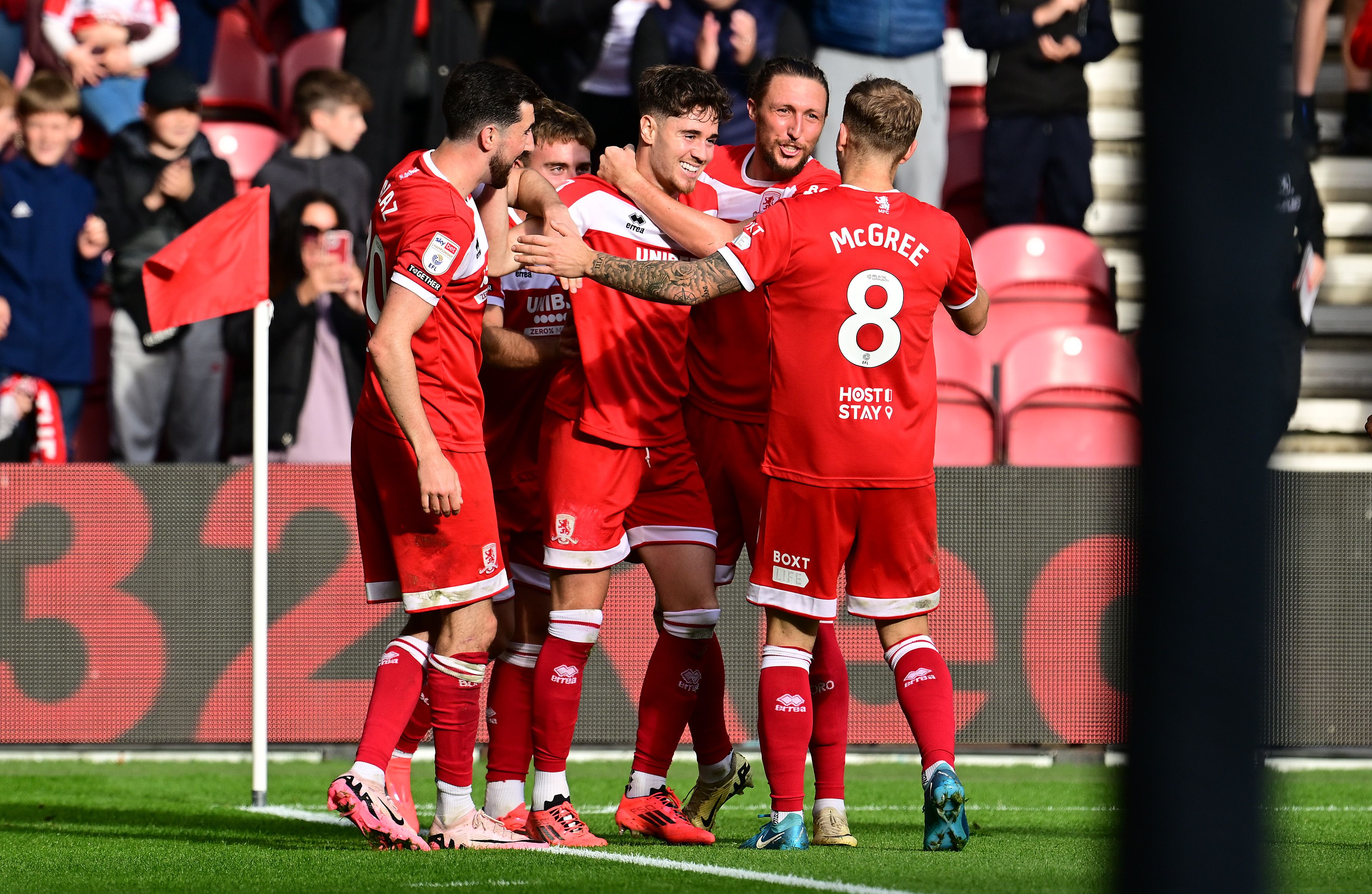 Several Middlesbrough players wearing their home kit celebrate a goal