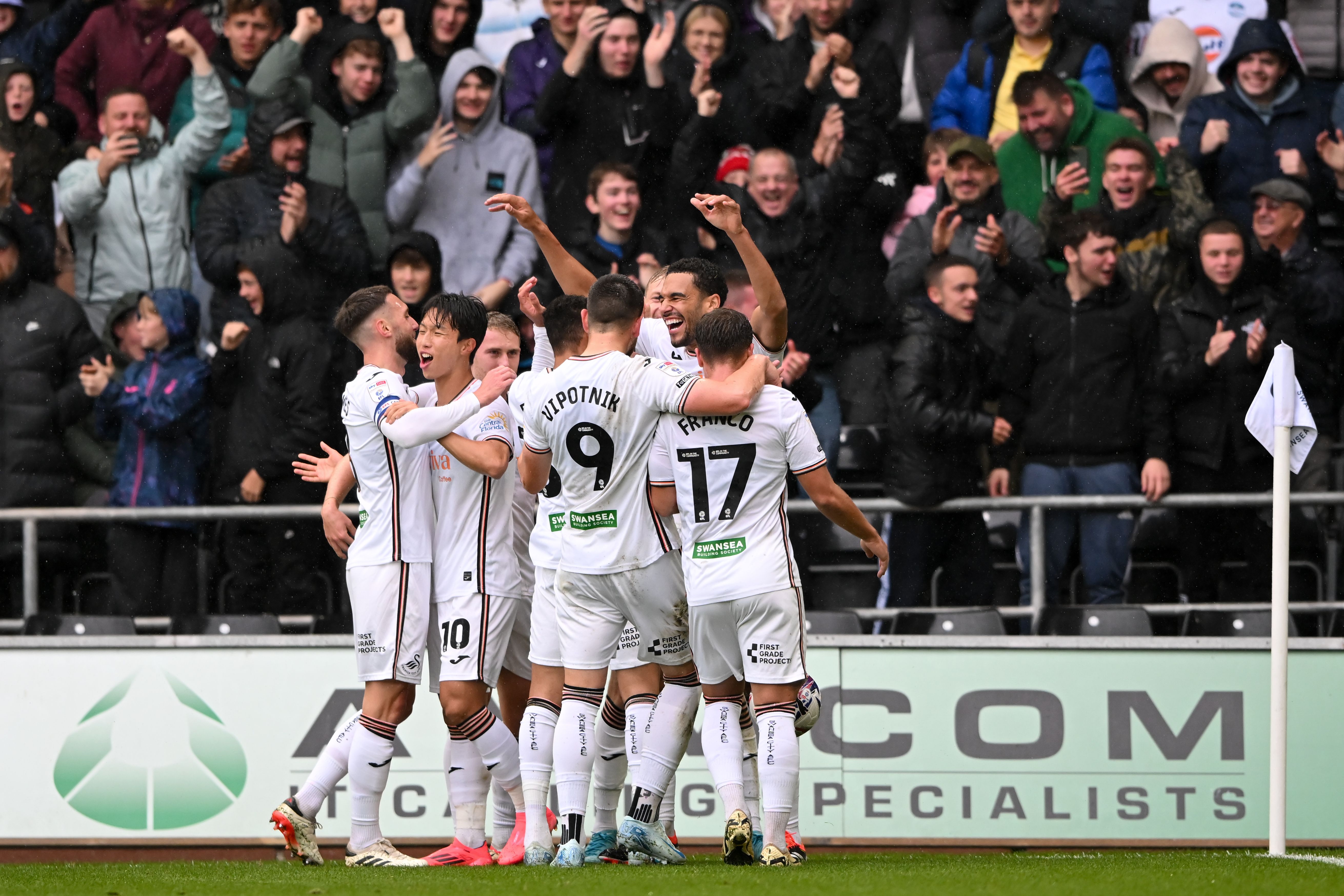 A general view of several Swansea City players celebrating a goal