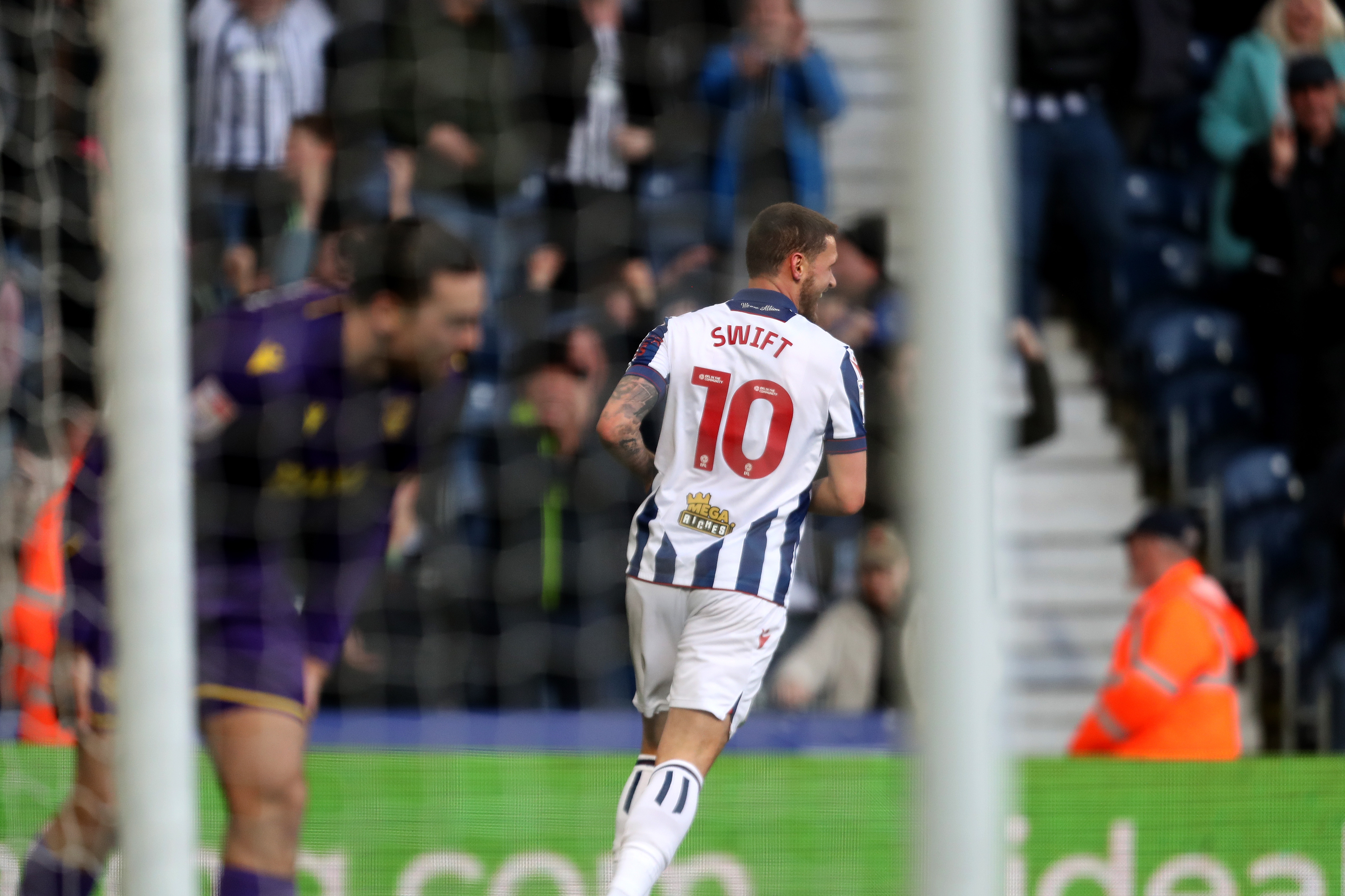 John Swift celebrates scoring against Oxford at The Hawthorns