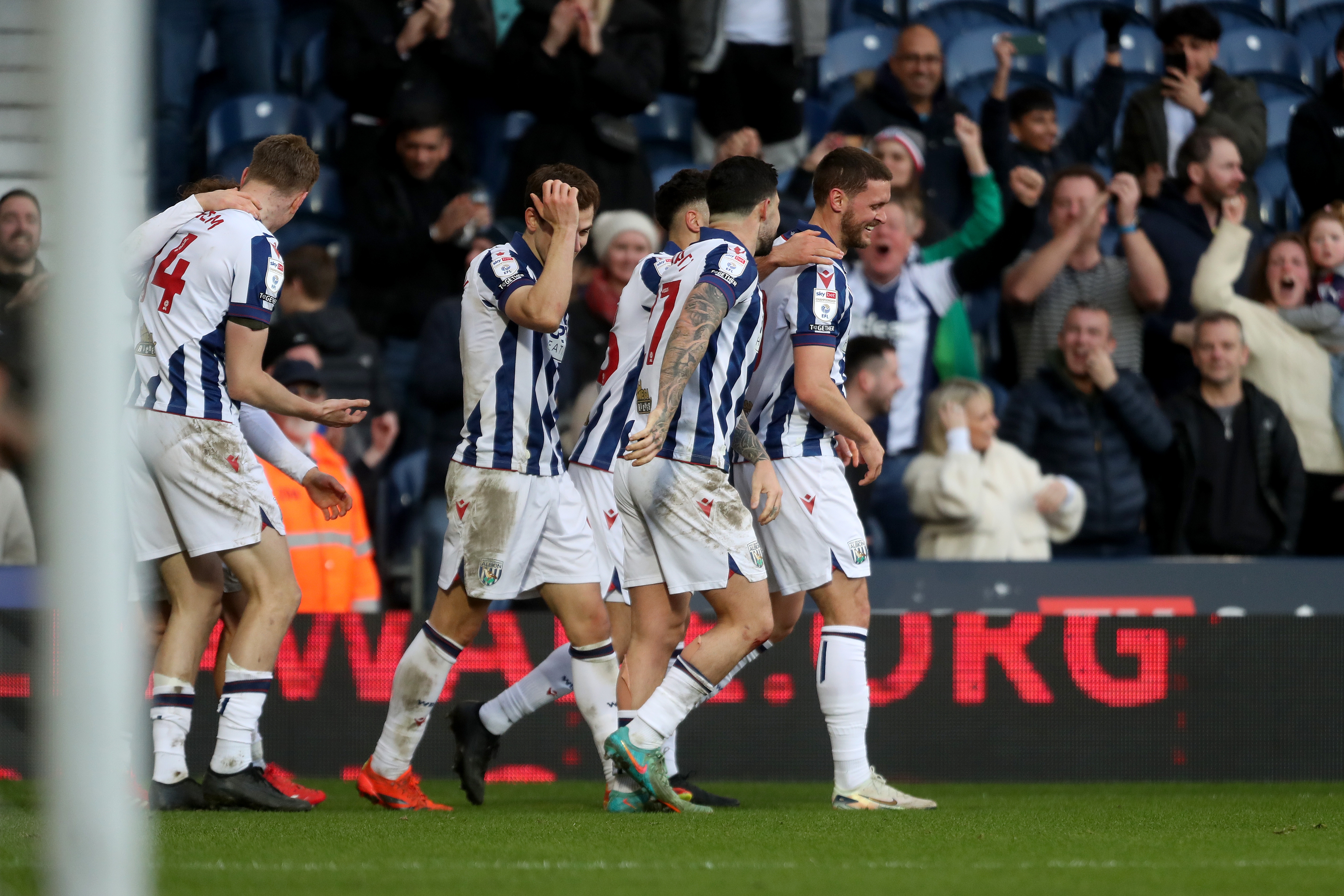 John Swift celebrates scoring against Oxford at The Hawthorns with team-mates