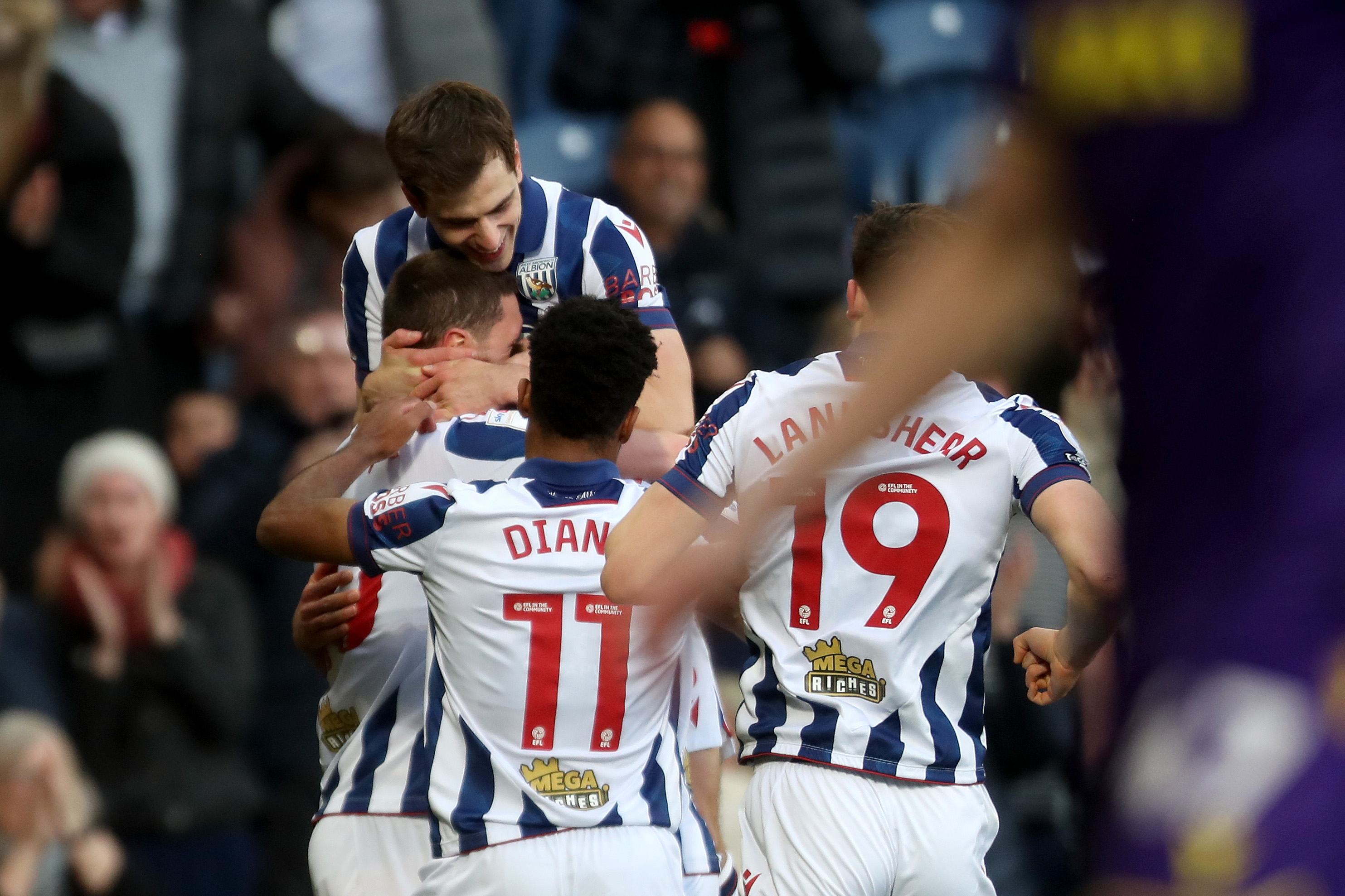 John Swift celebrates scoring against Oxford at The Hawthorns with team-mates