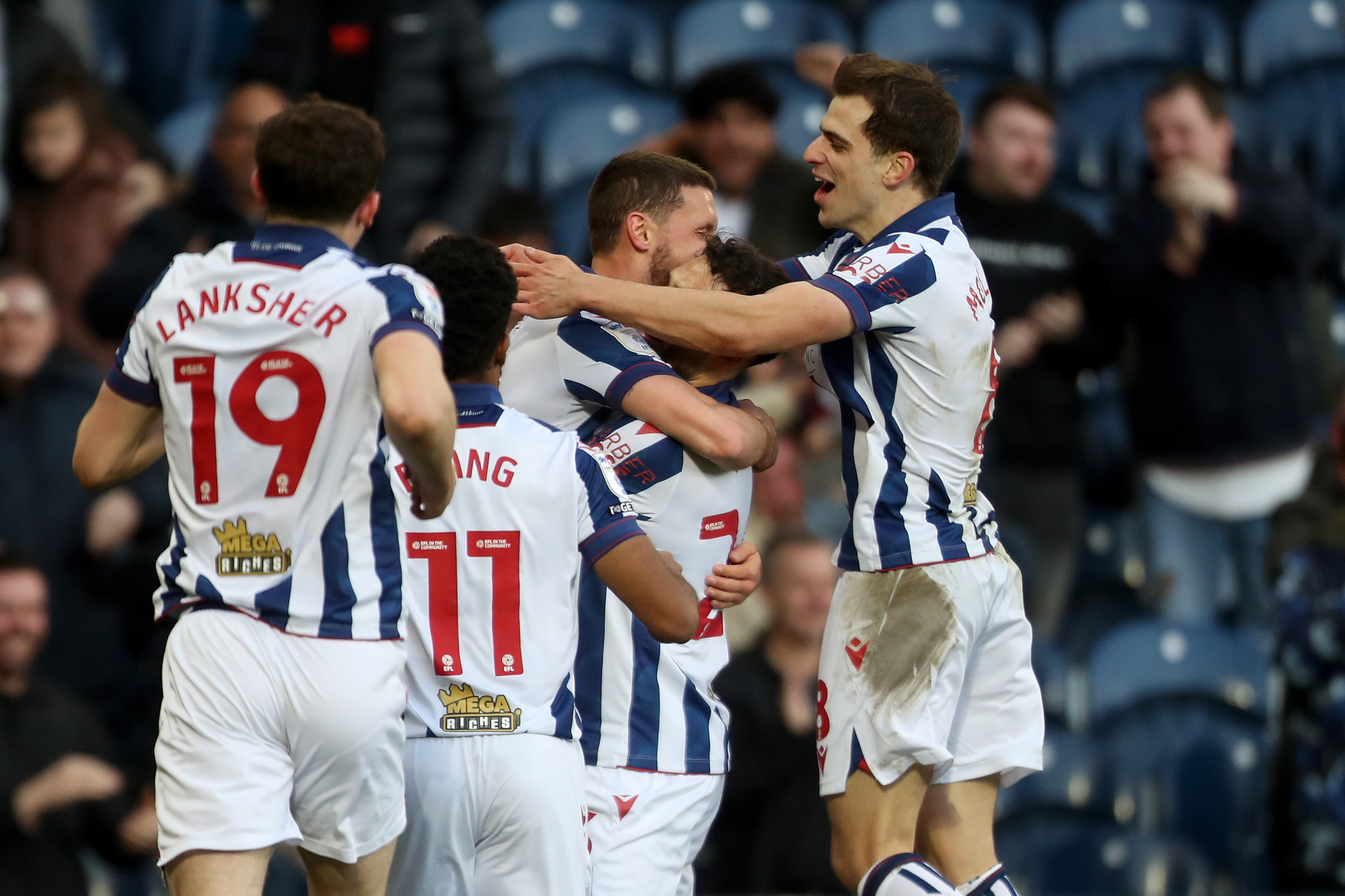 John Swift celebrates scoring against Oxford at The Hawthorns with team-mates