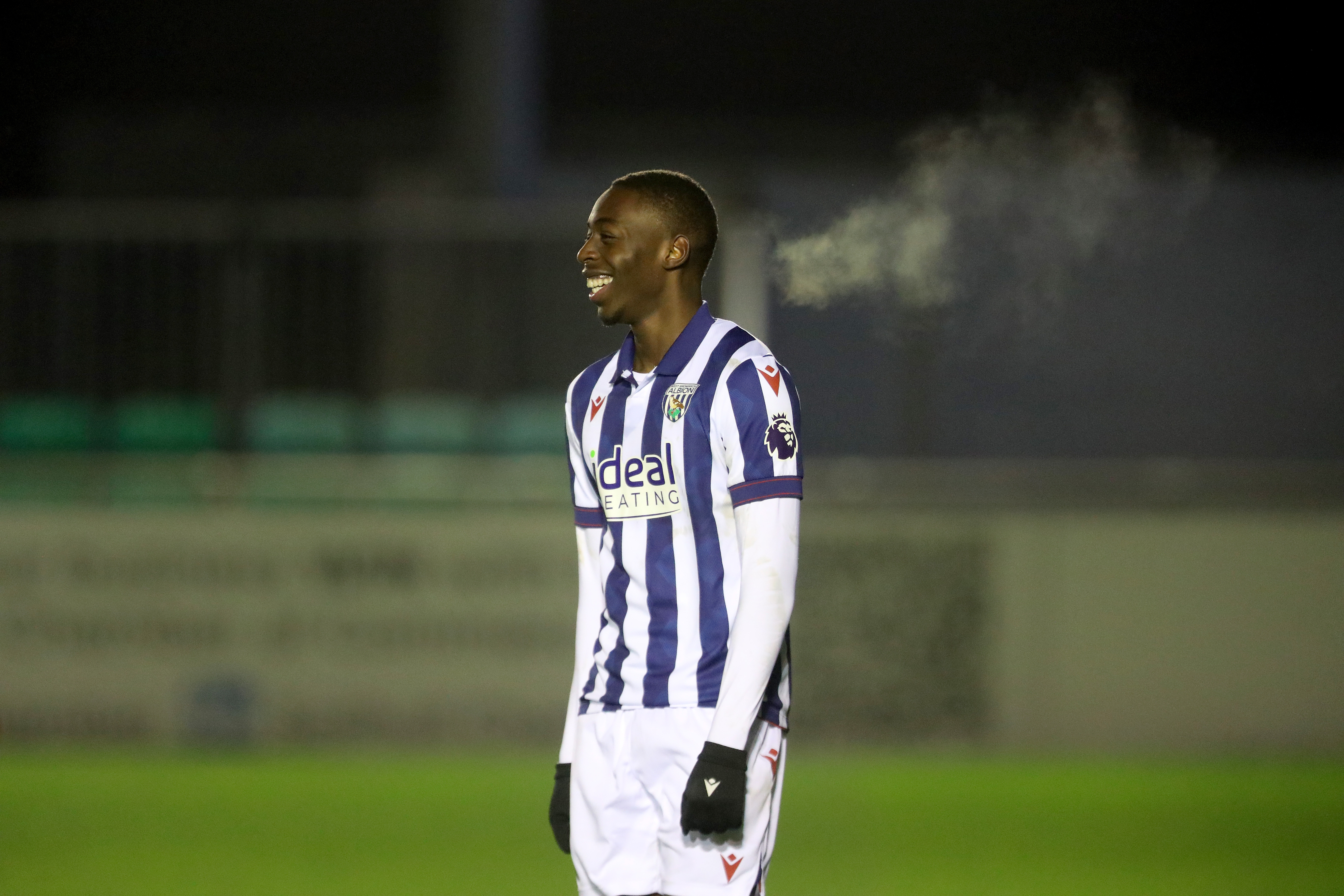 Eseosa Sule smiling while playing for Albion's PL2 team in the home kit 