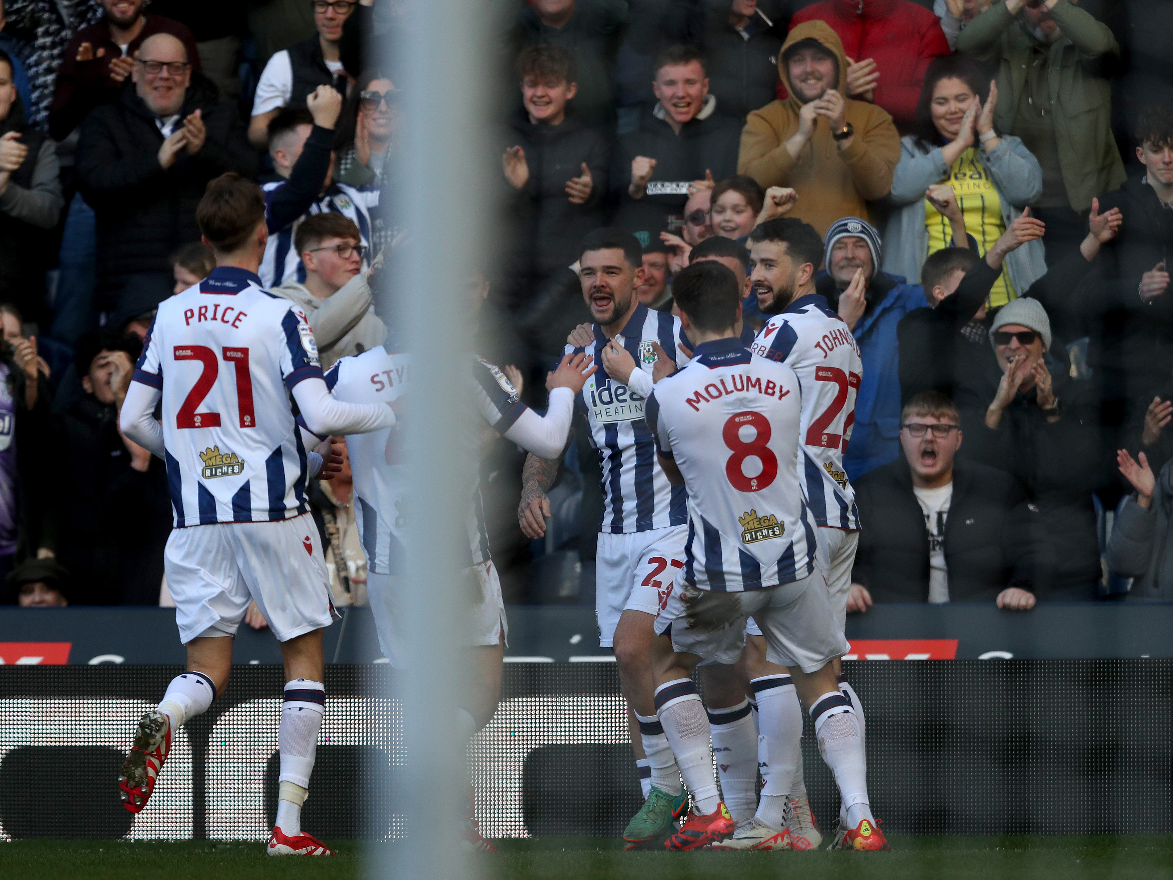 Albion players celebrate with Alex Mowatt in the home kit after his goal against Oxford 