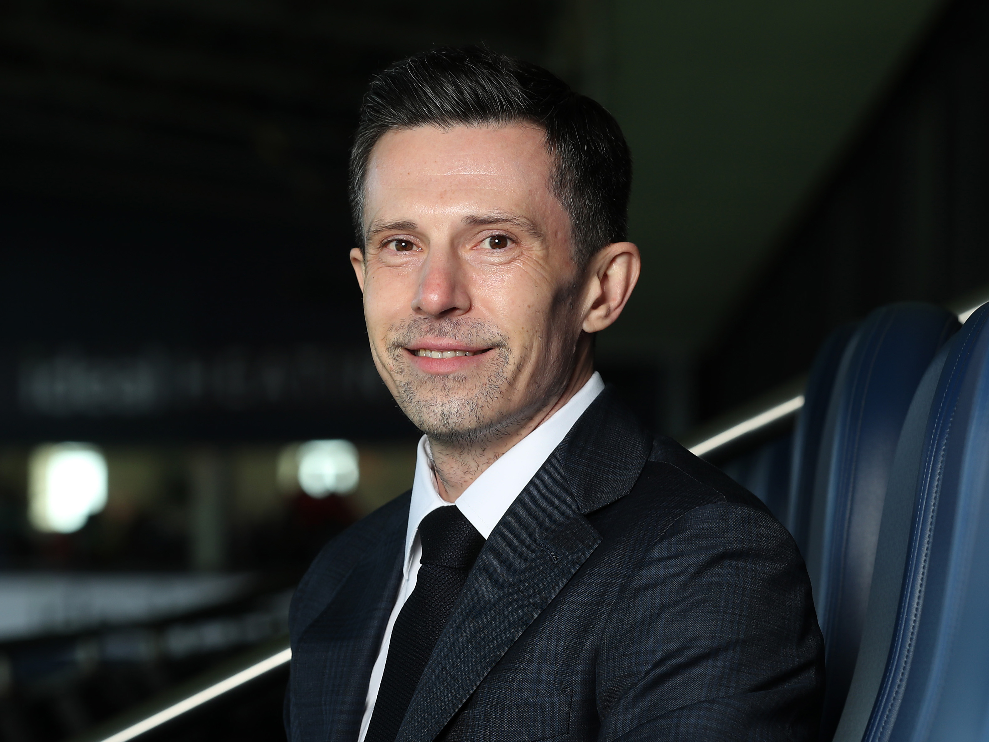 Andrew Nestor smiling at the camera while sat in a suite at The Hawthorns 