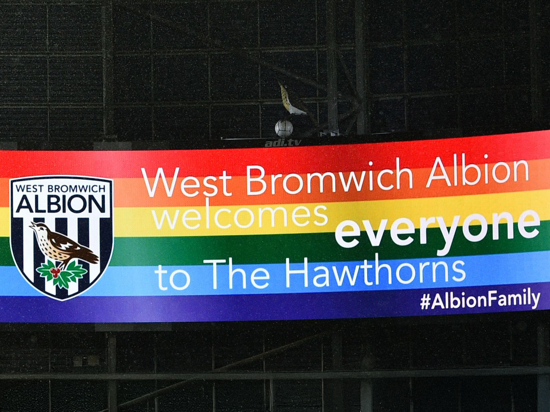 An image of a rainbow banner on the big screen that says 'West Bromwich Albion welcomes everyone to The Hawthorns'