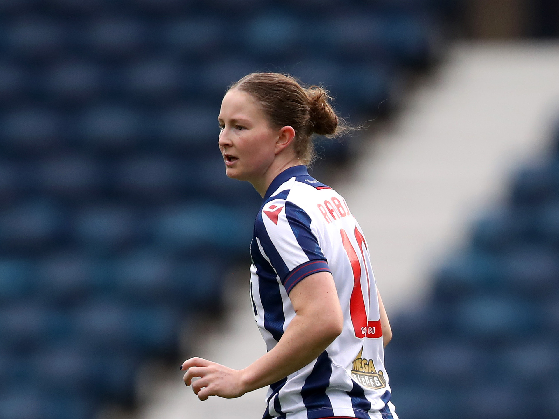 Olivia Rabjohn in action for Albion Women wearing the home kit