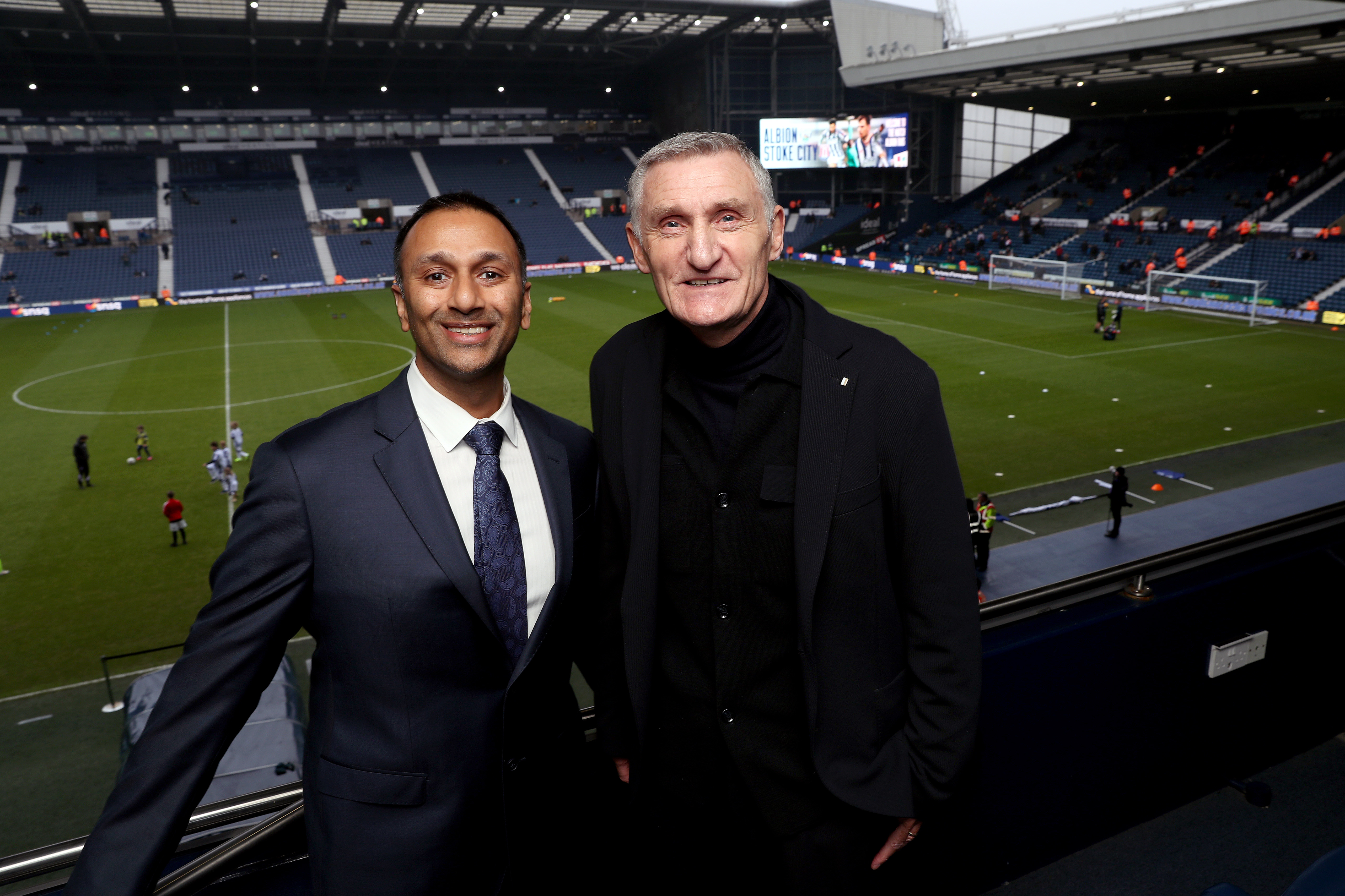 Chairman Shilen Patel and Head Coach Tony Mowbray posing together for a photo on the balcony at The Hawthorns