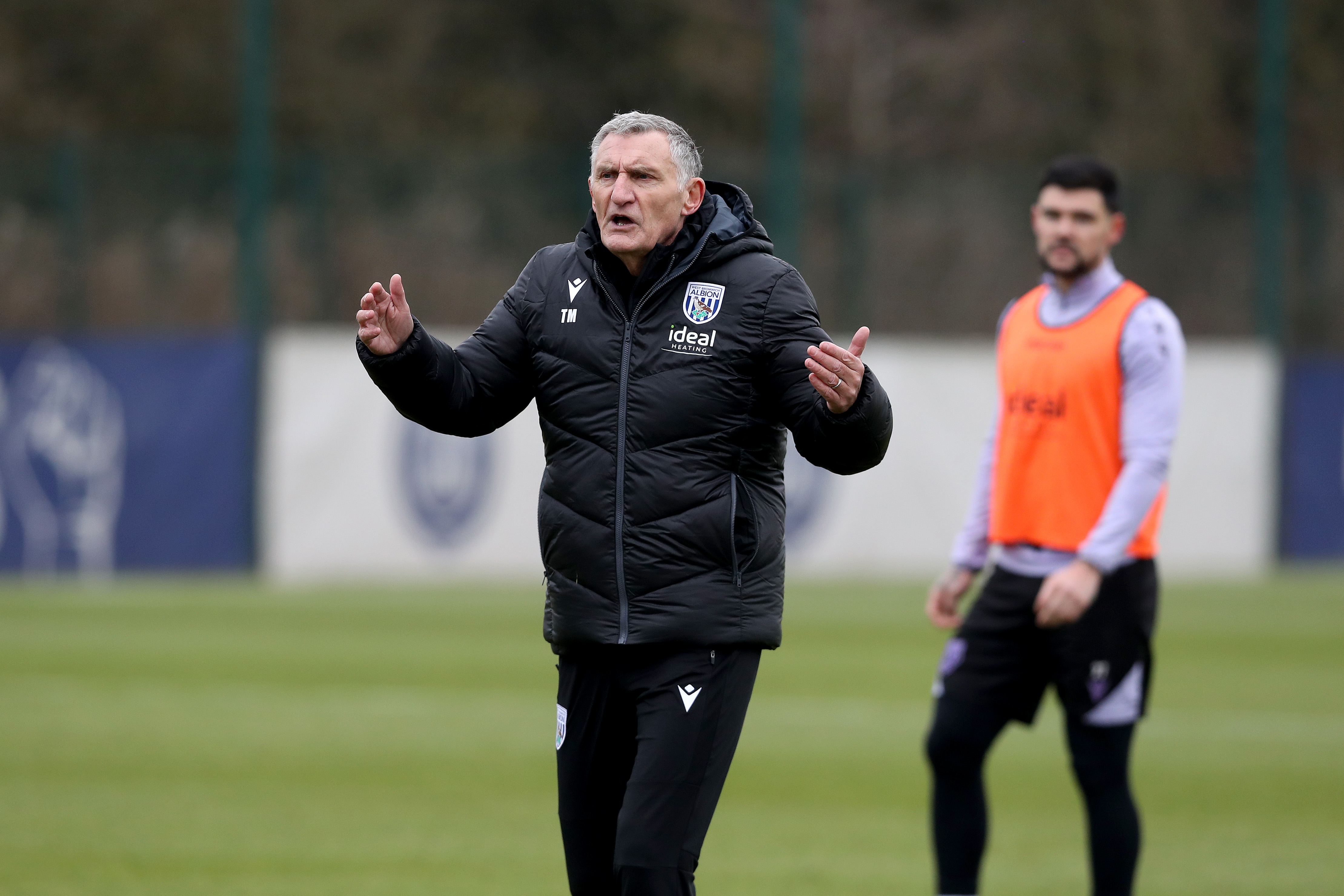 Tony Mowbray delivering info to players on the training pitch 