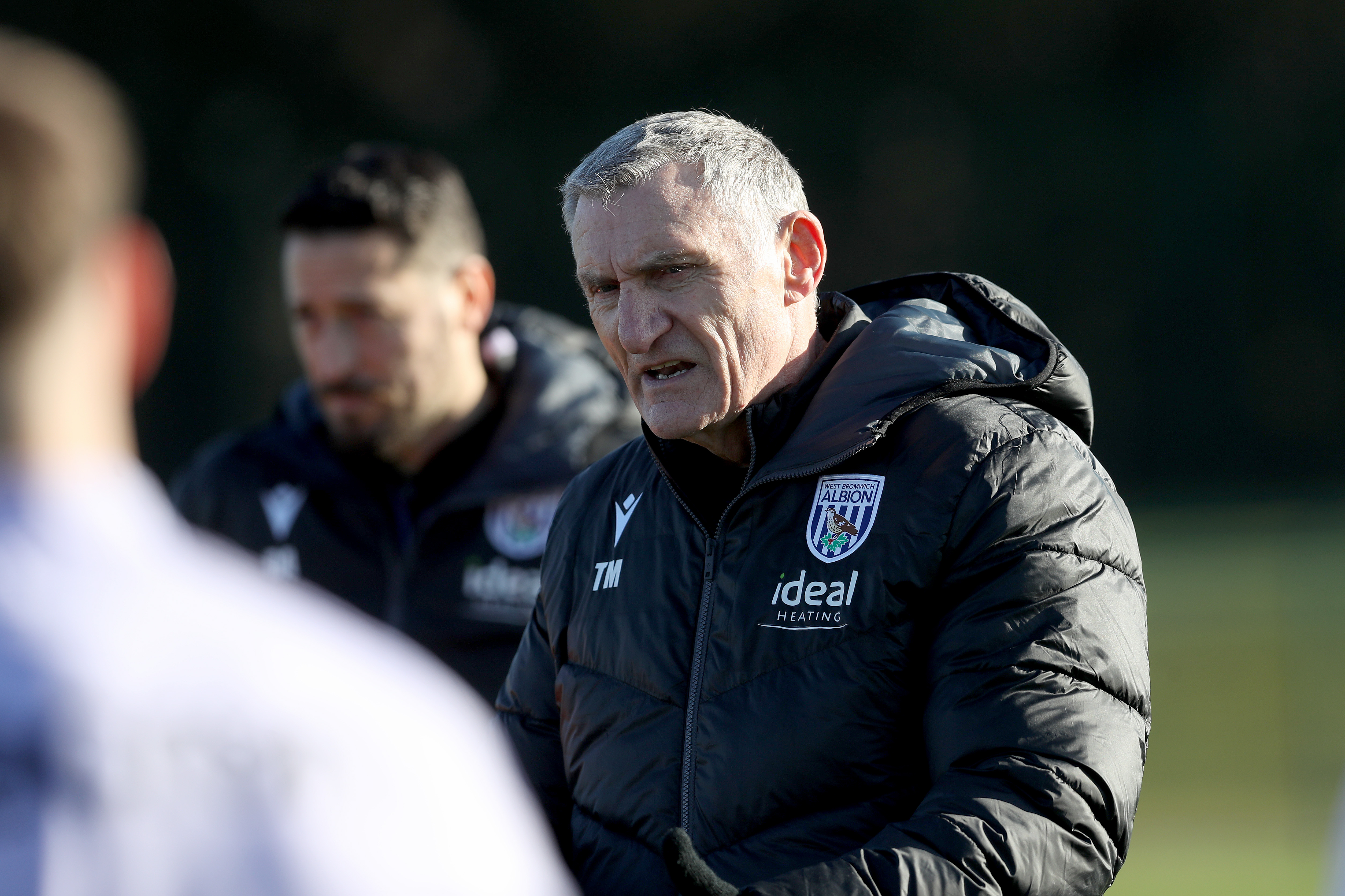 Tony Mowbray talking to players on the training pitch 