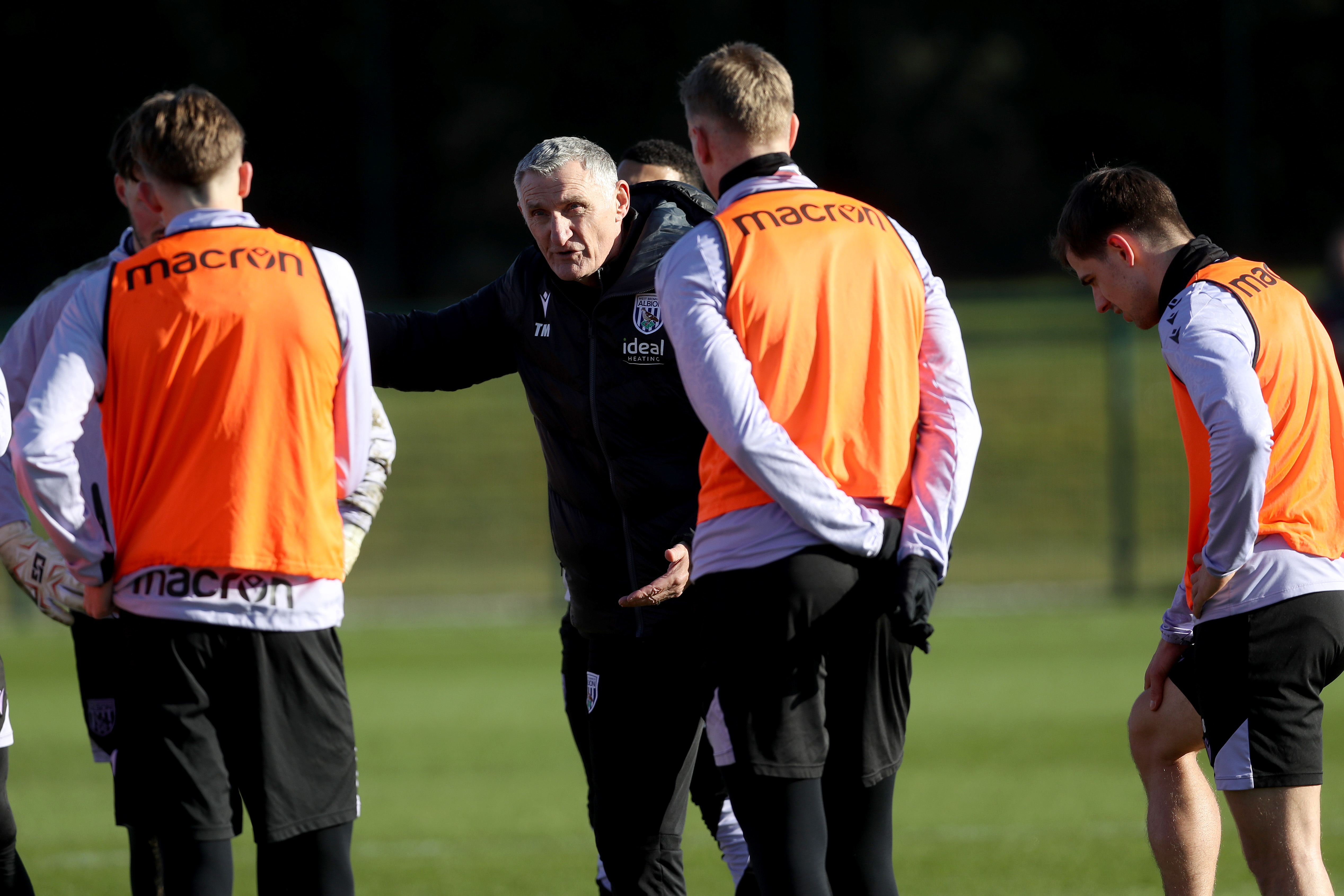 Tony Mowbray talking to players on the training pitch 