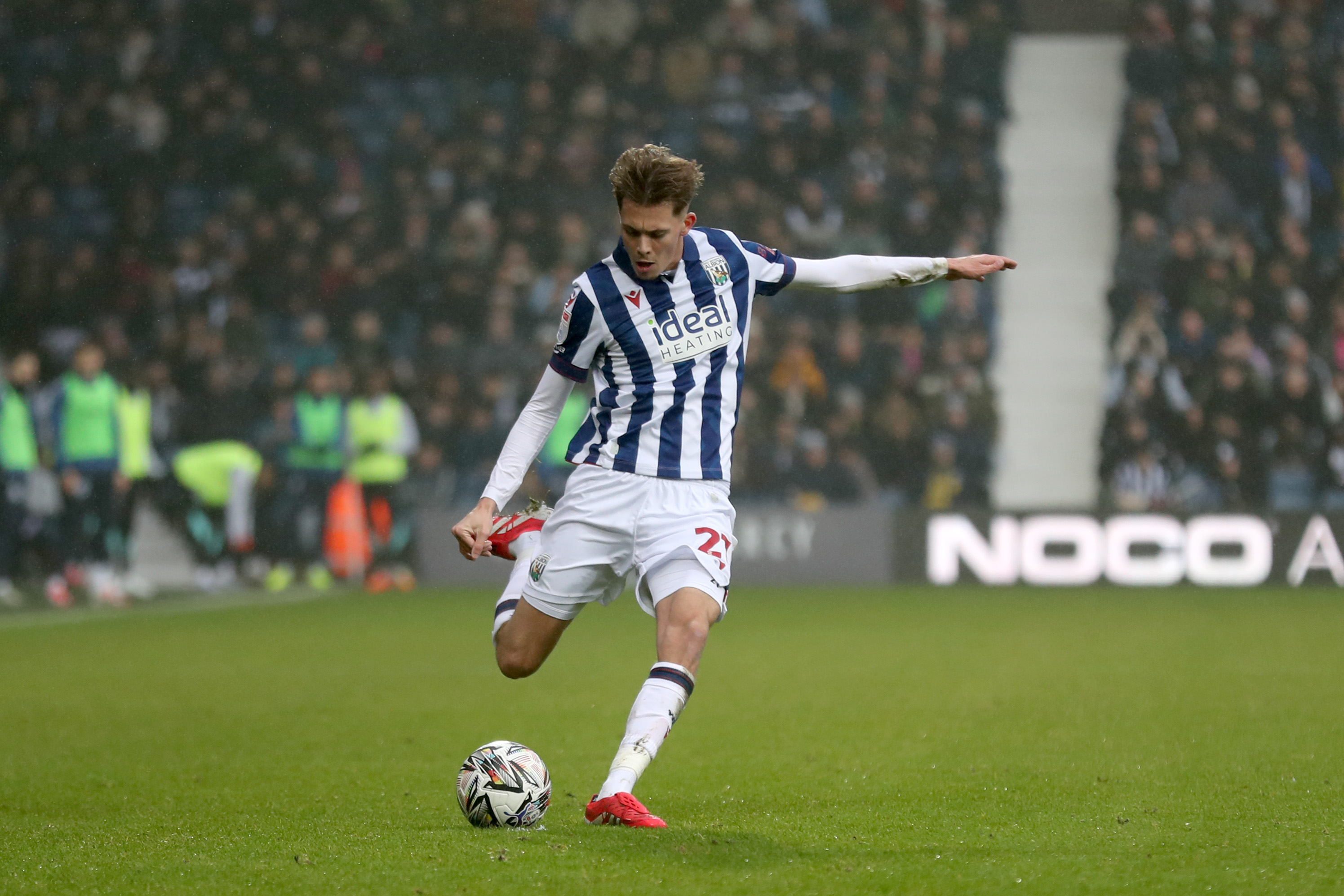 Isaac Price taking a free-kick in the home kit at The Hawthorns 