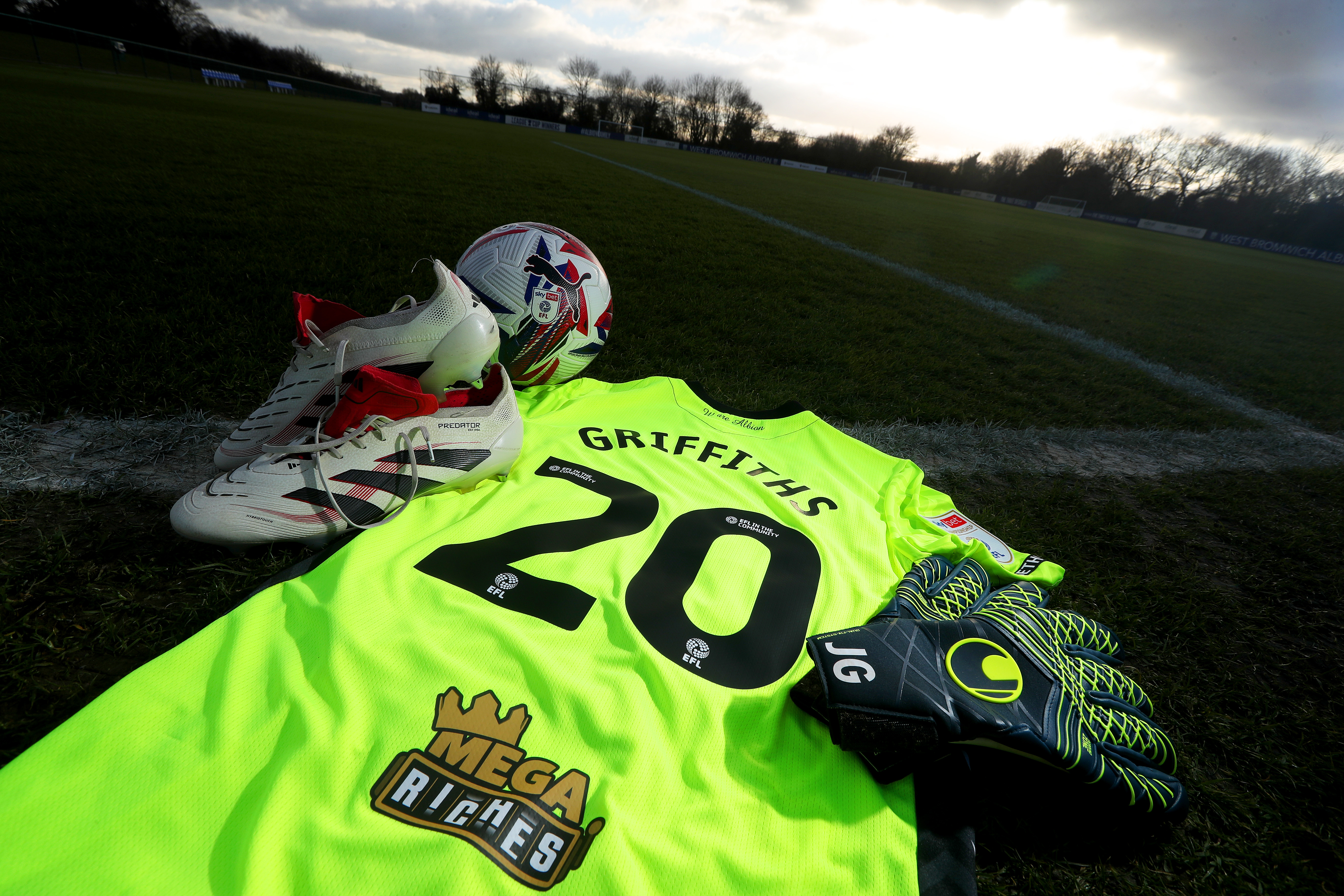 Josh Griffiths number 20 shirt laid out on a pitch with his boots and his gloves